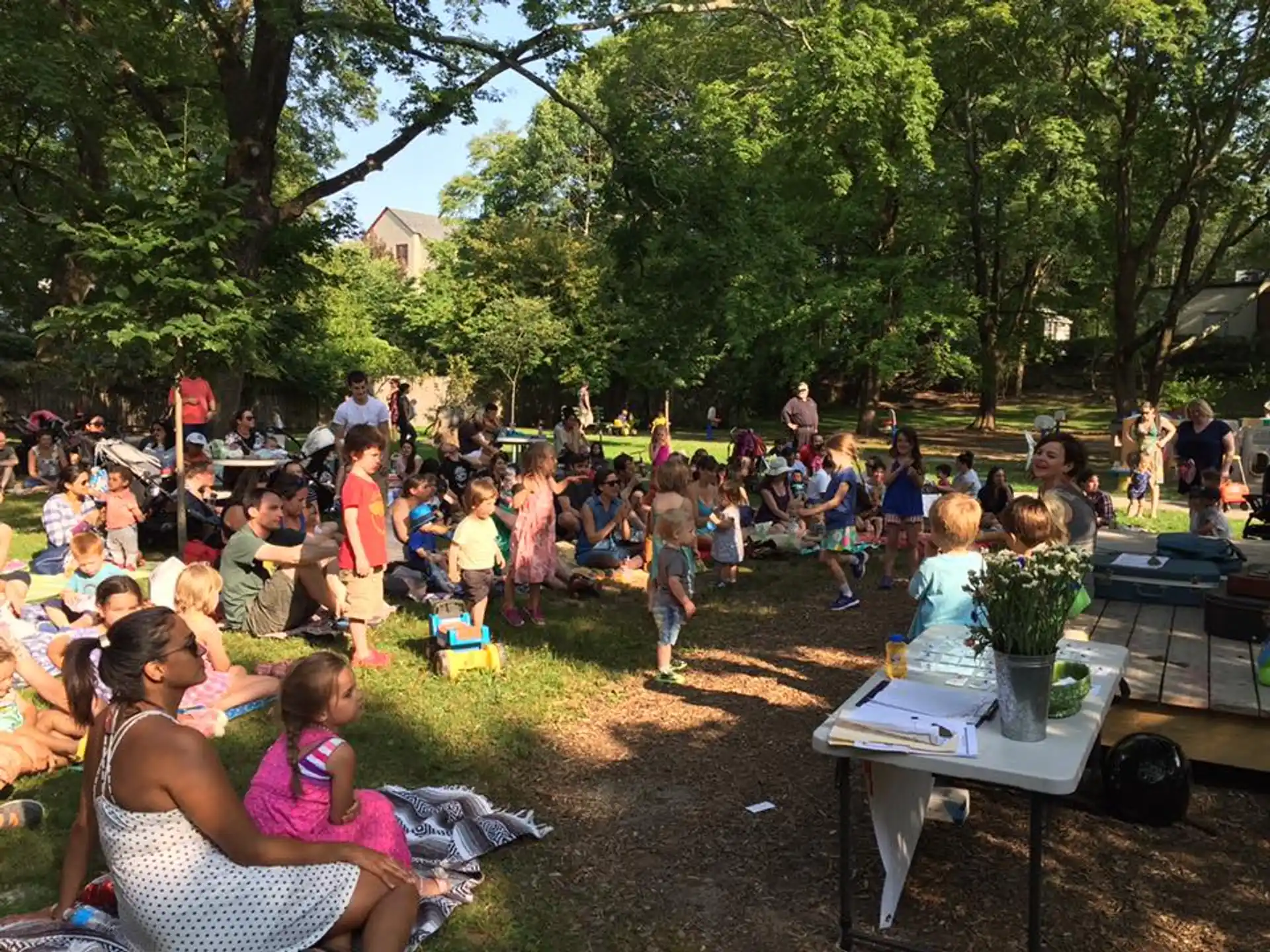 a large group of people sitting on the grass