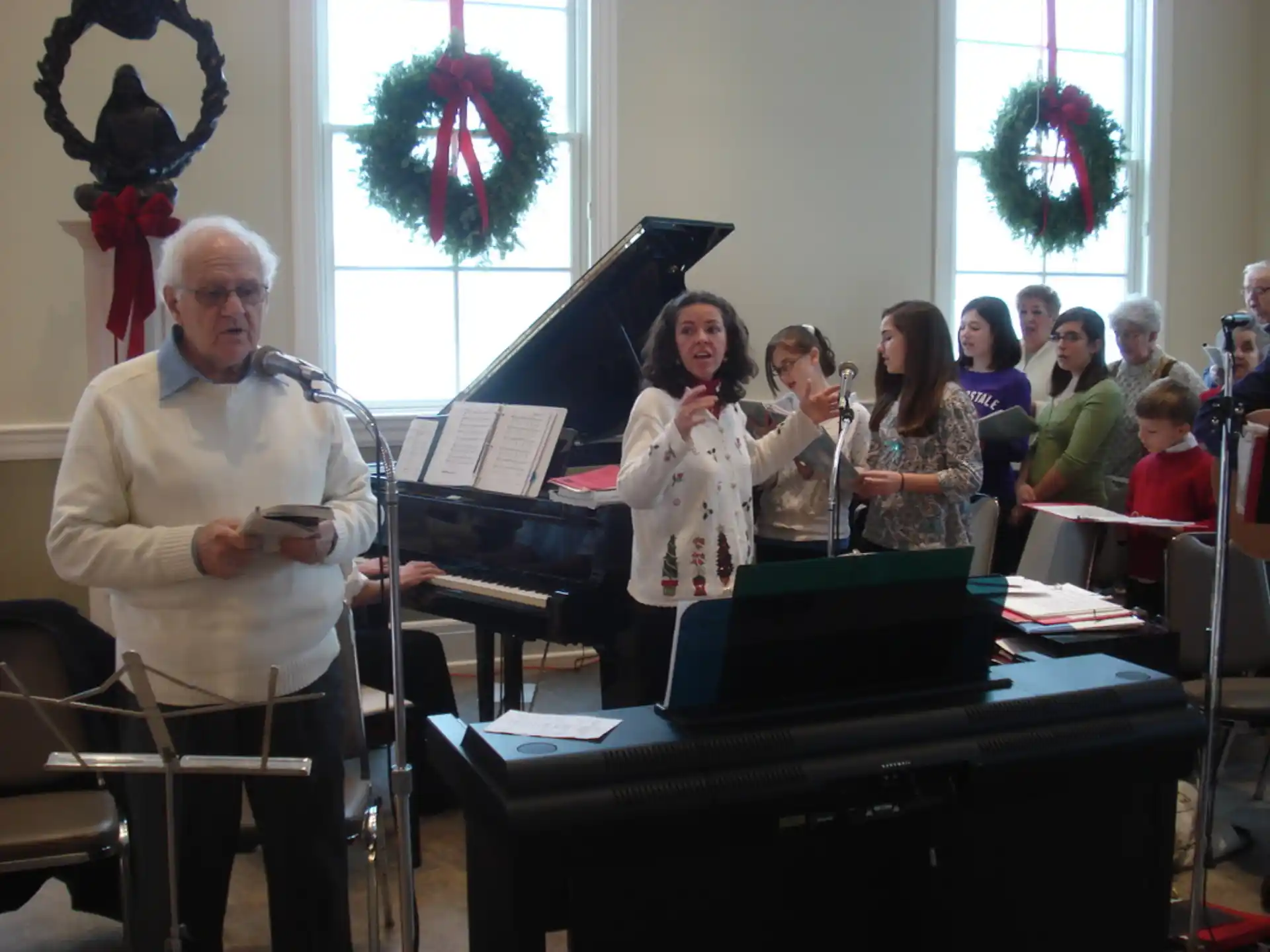 a person playing a piano in front of a group of people