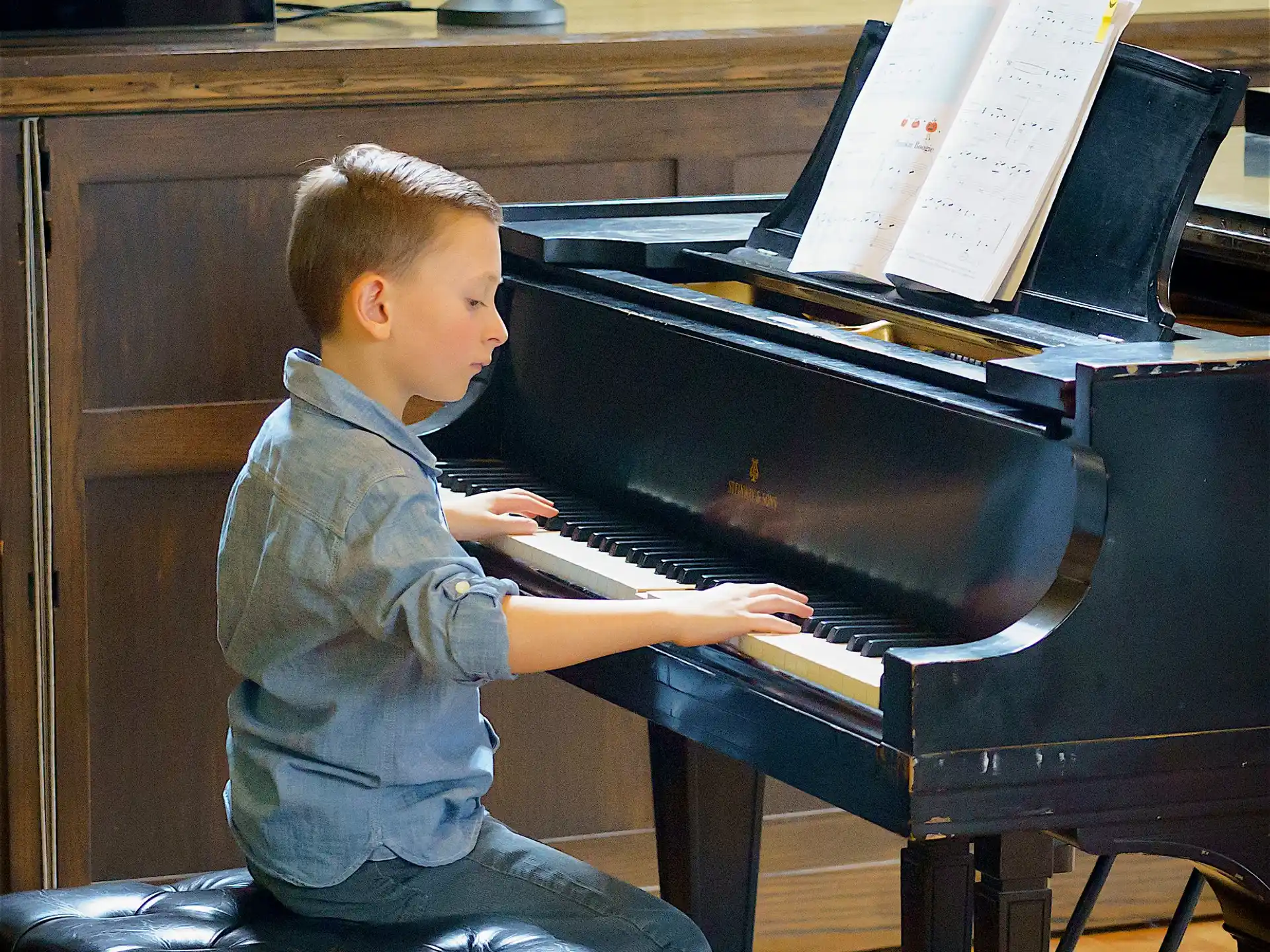 a boy playing a piano