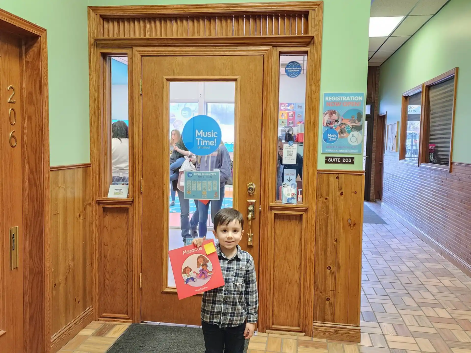 a boy holding a sign in a hallway