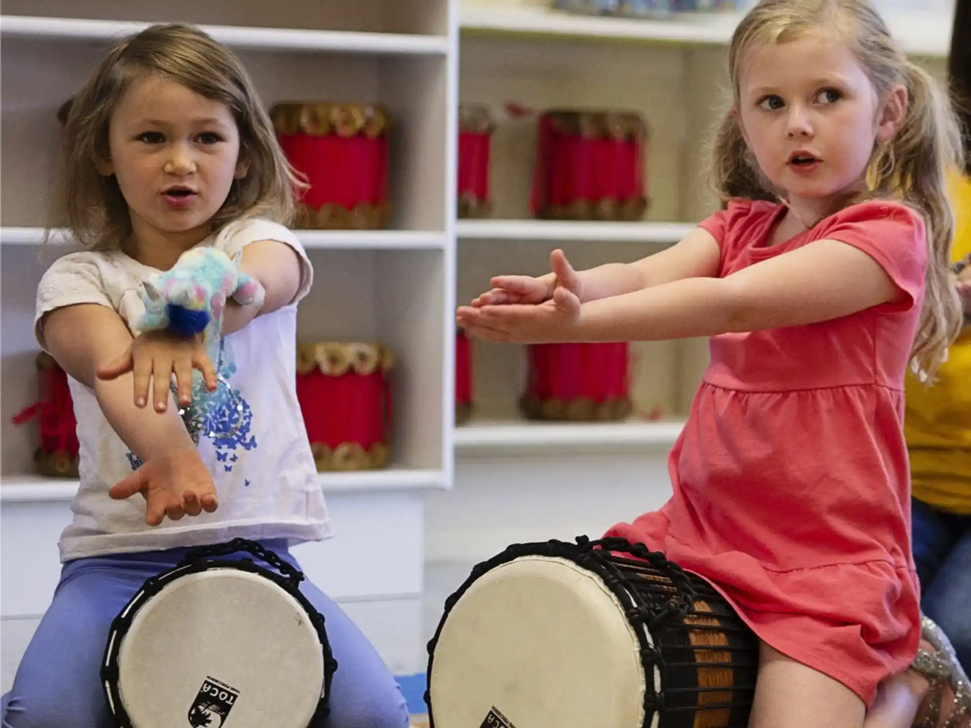 a couple of girls playing drums