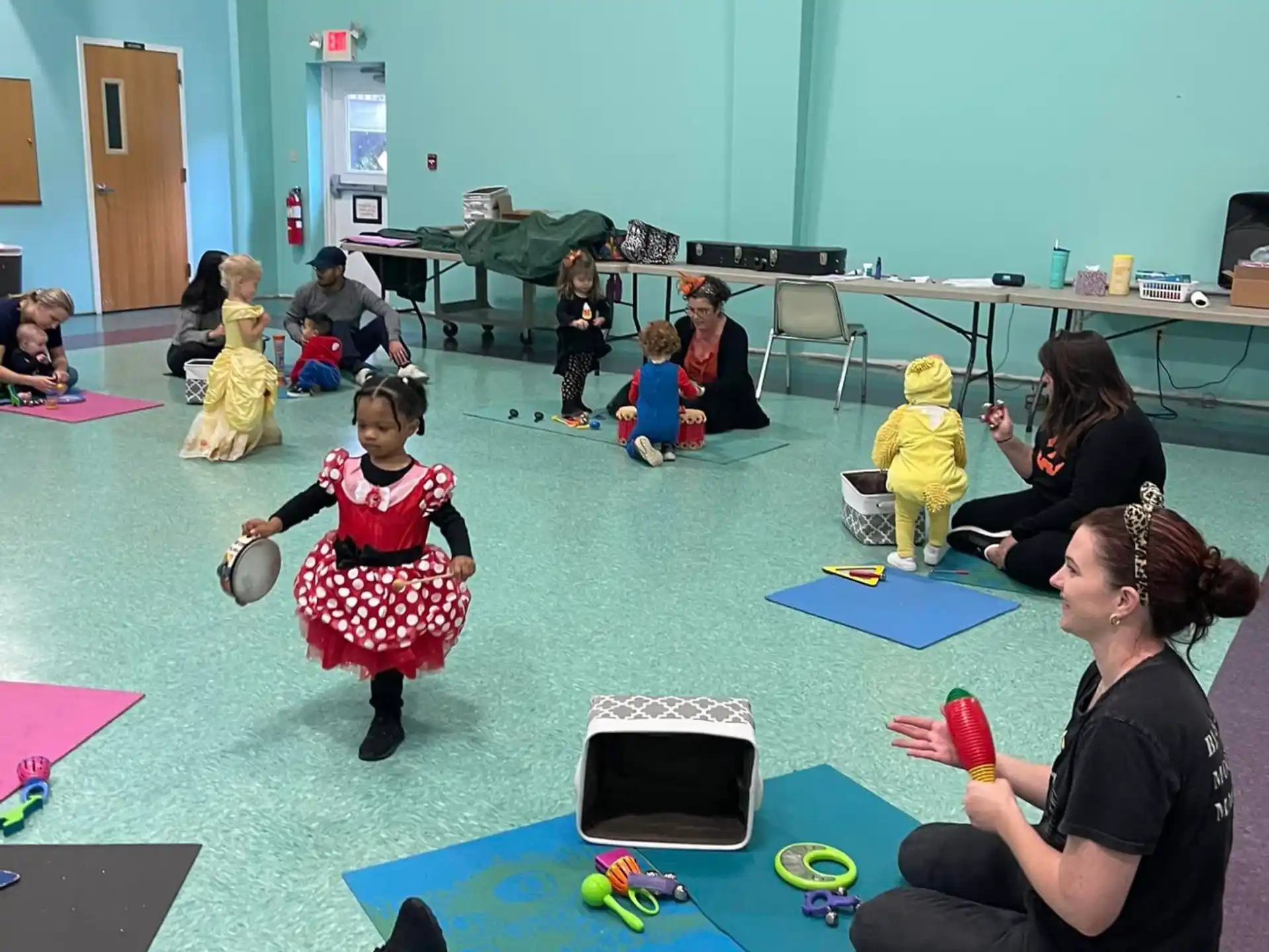 a group of children sitting on mats in a classroom