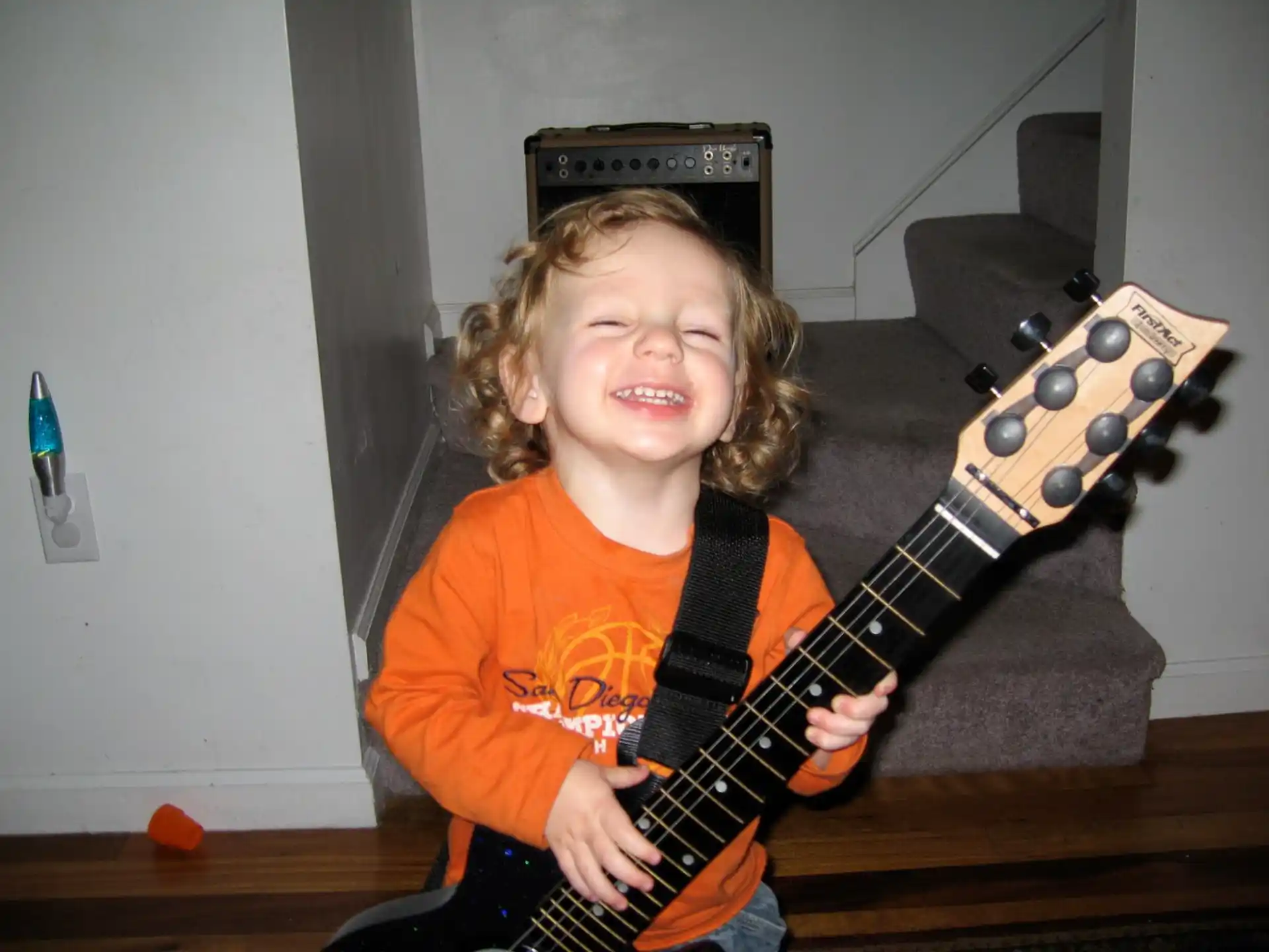 a child playing a guitar