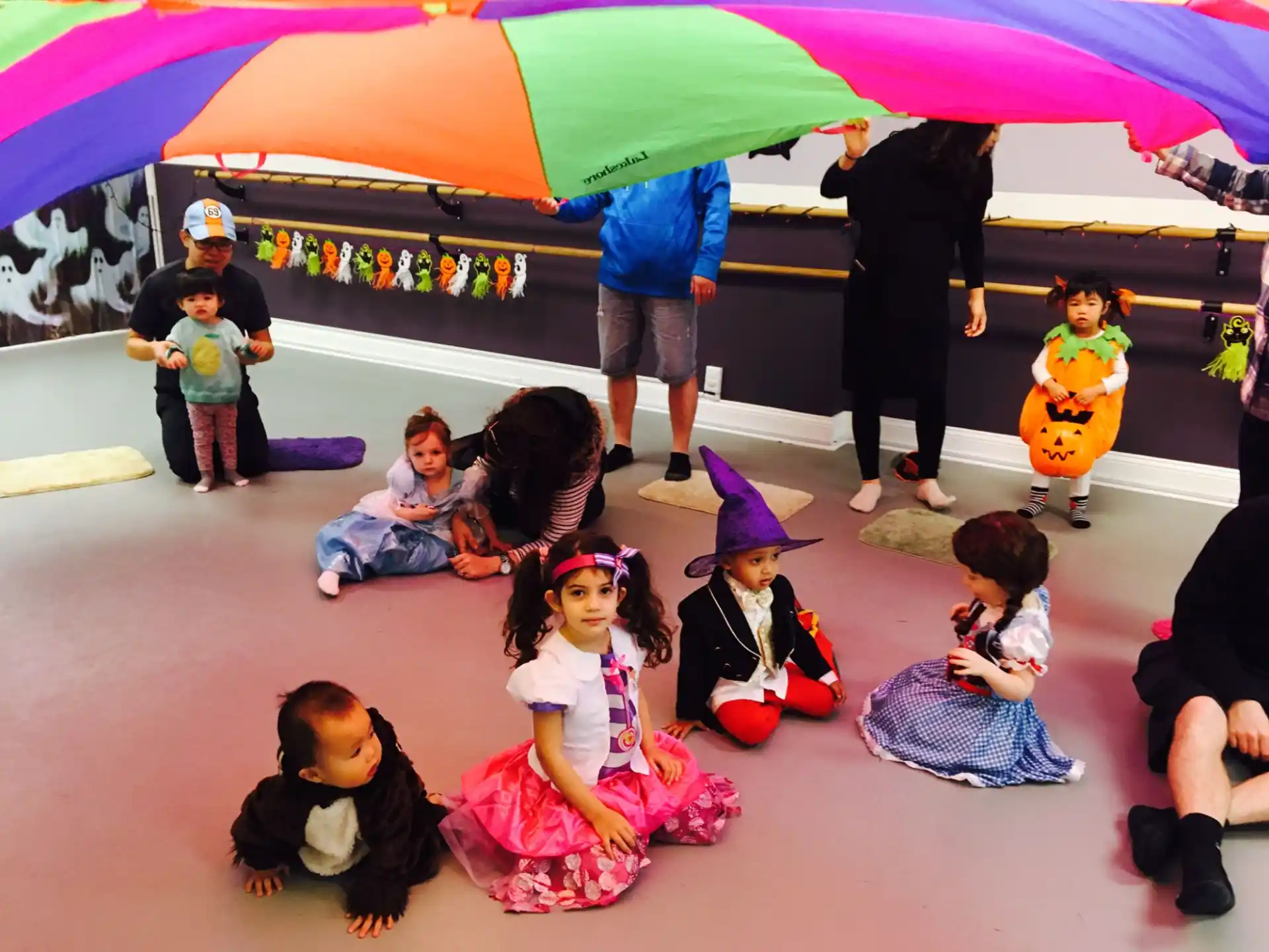 a group of children under an umbrella