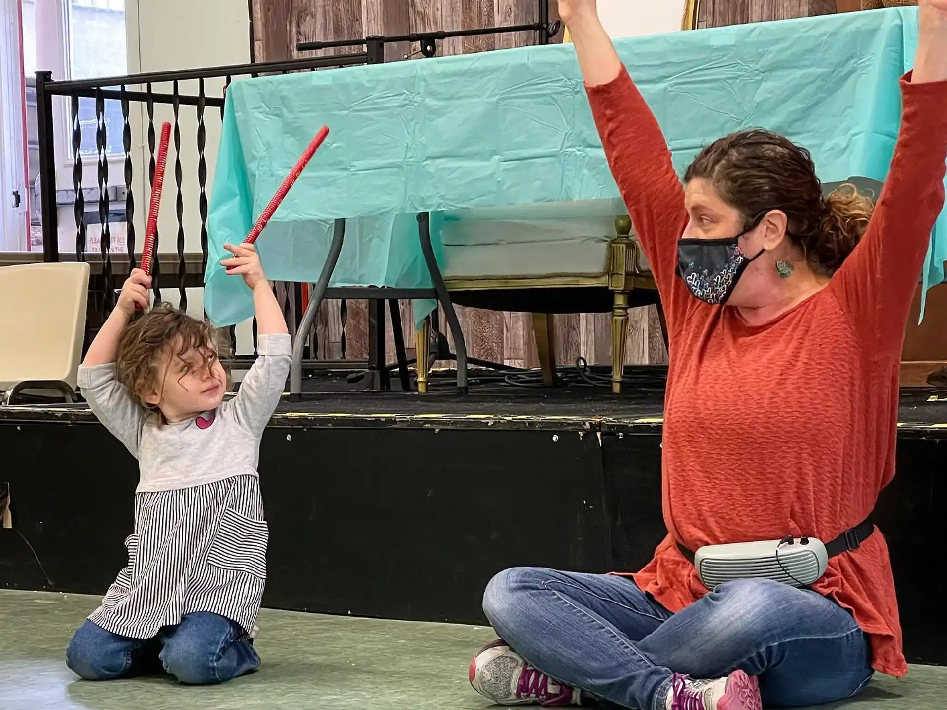 a person and a child playing with a toy
