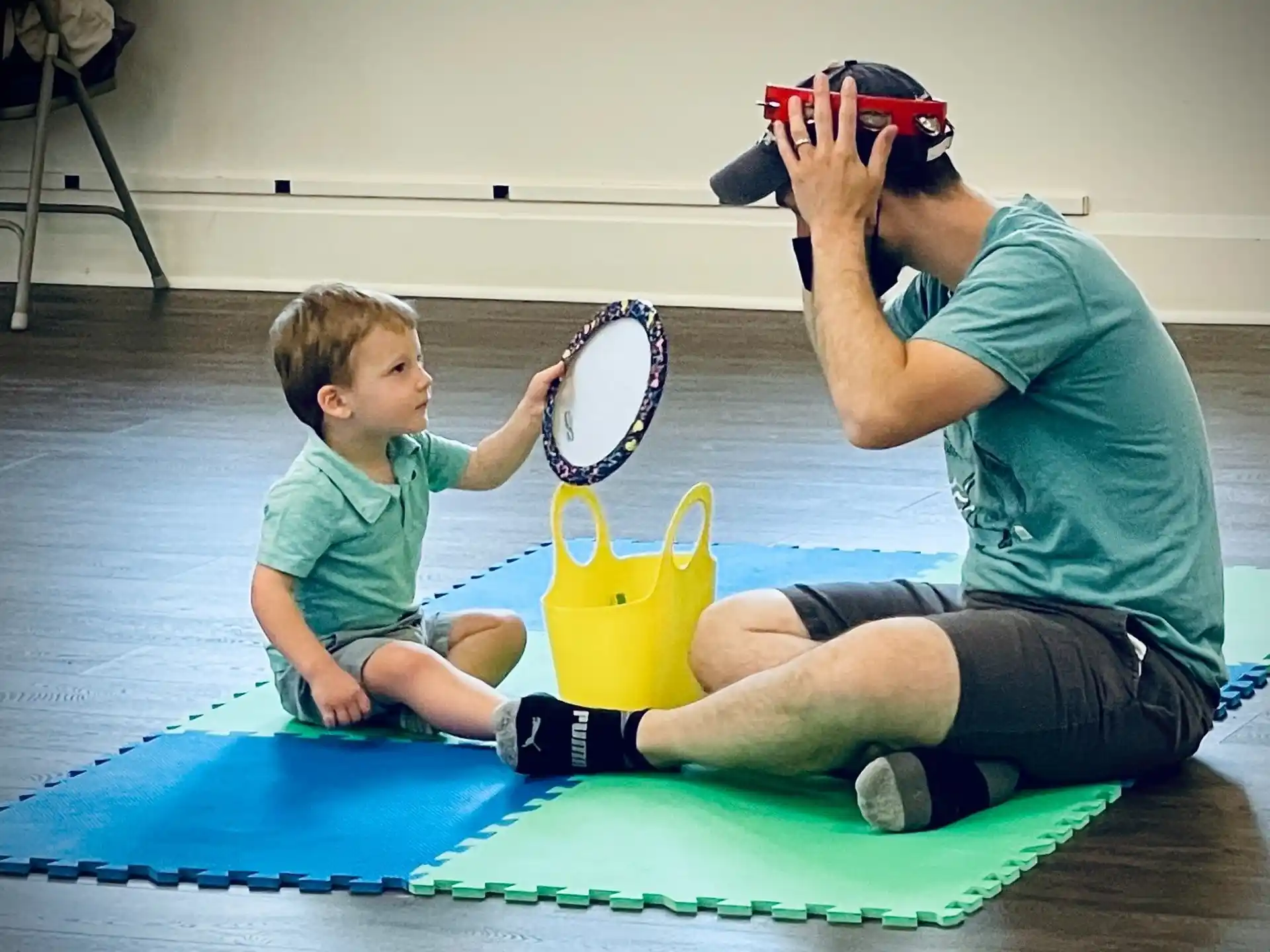 a person and a boy playing with a toy