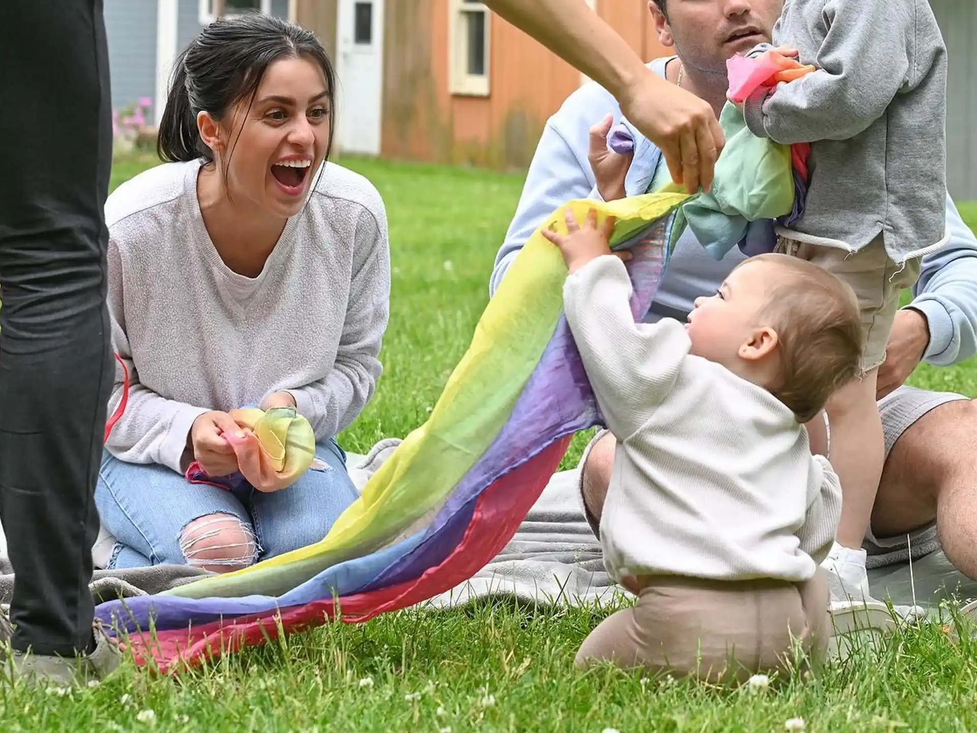 a person and a couple of children playing with a kite