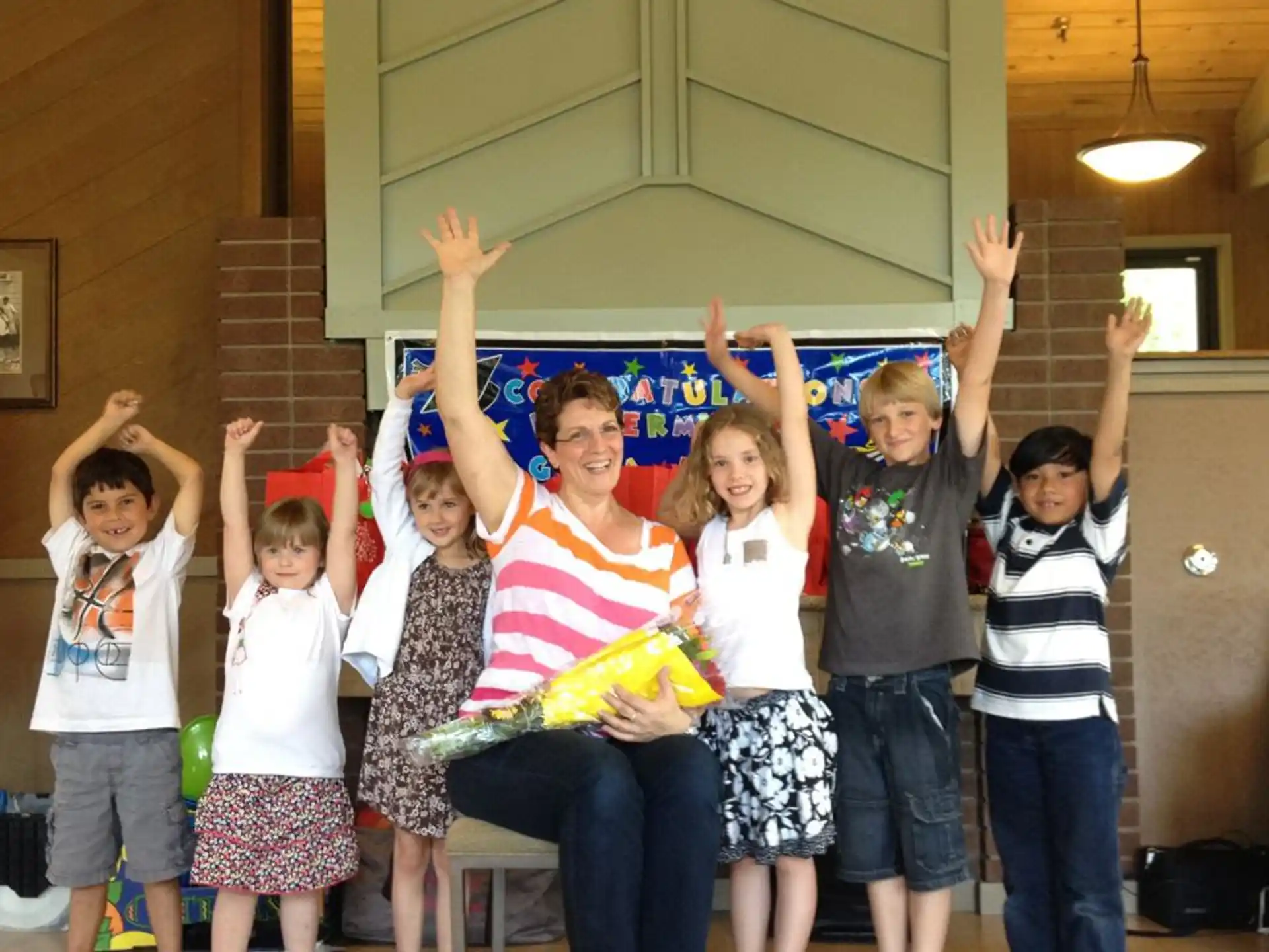 a group of children raising their hands