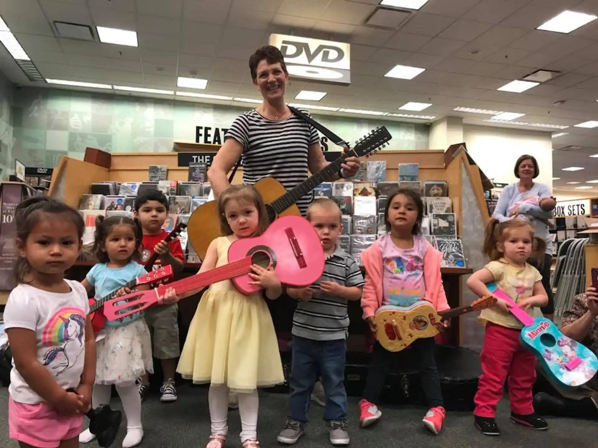 a group of kids holding a guitar