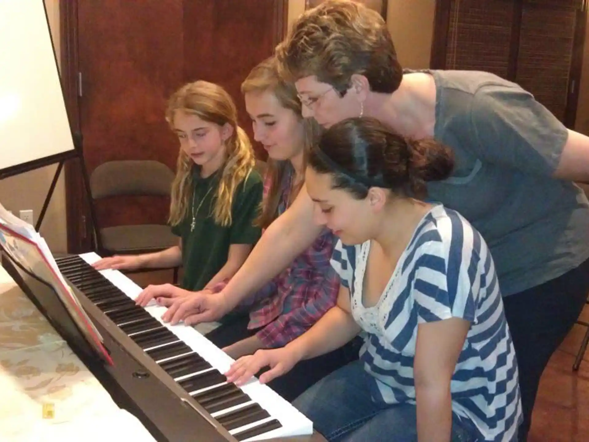 a group of people playing a piano