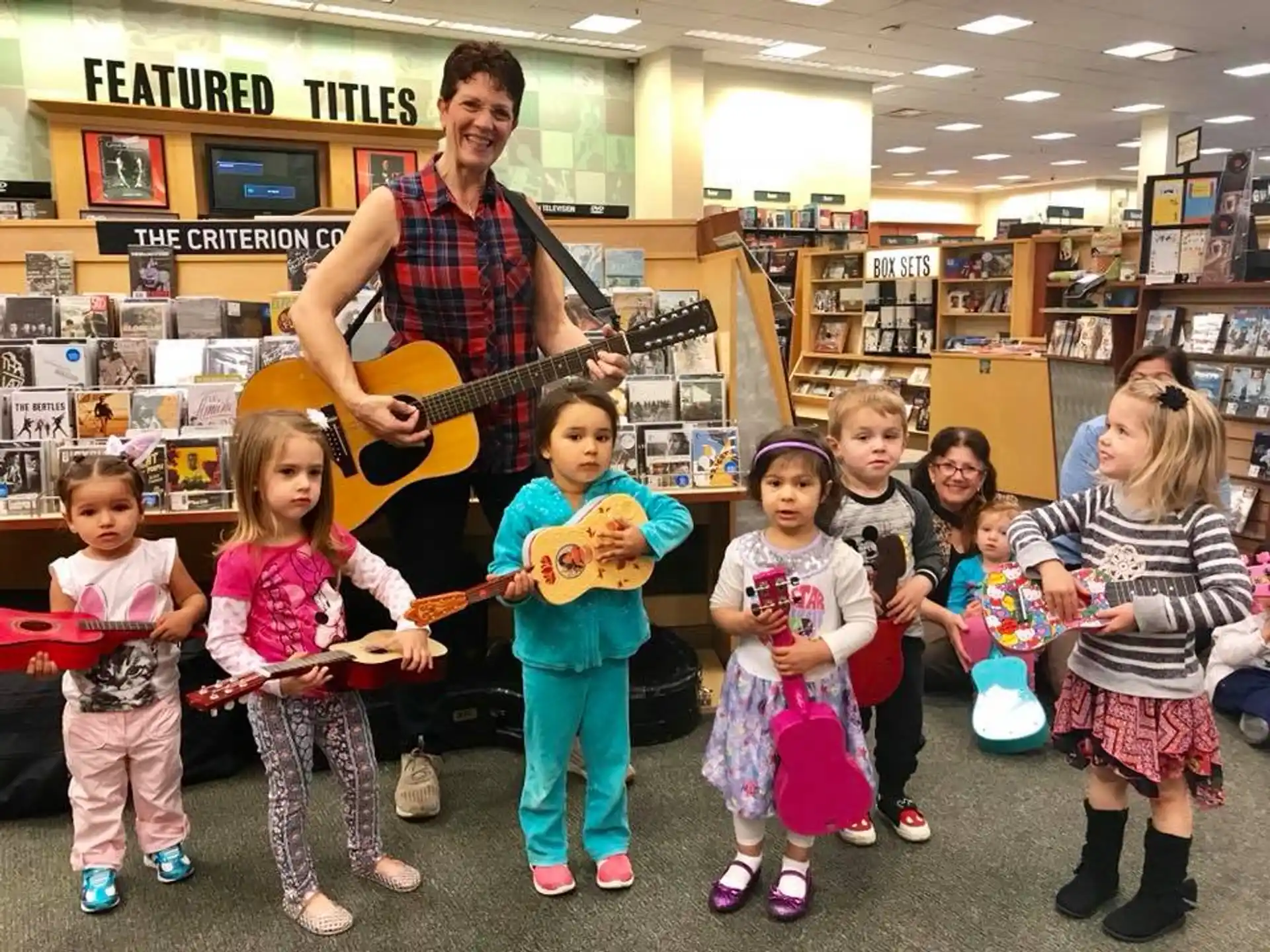 a person playing guitar with children