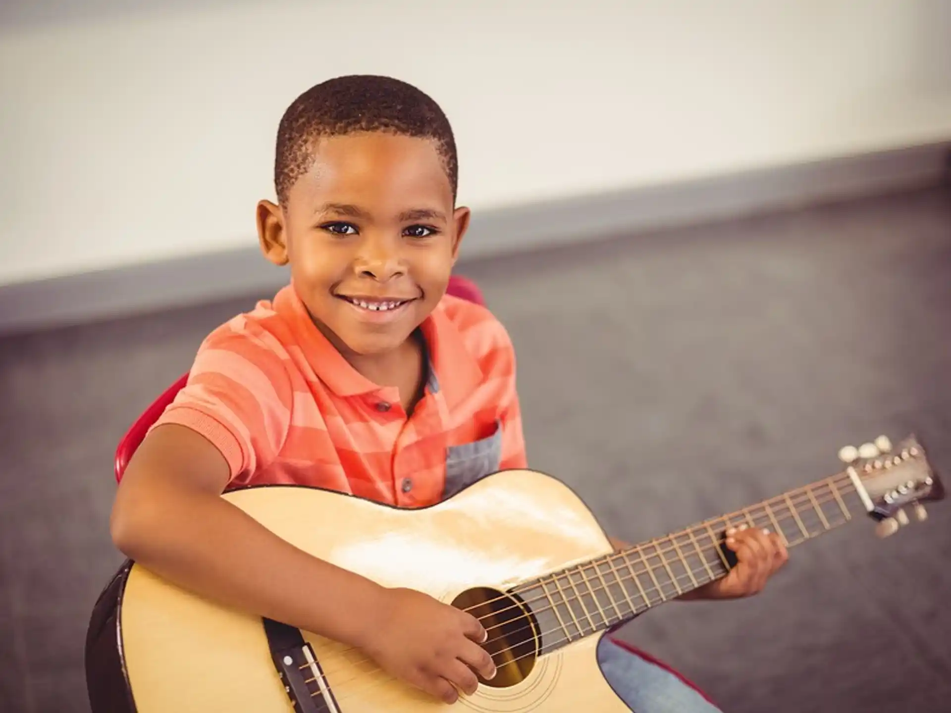 a boy playing a guitar