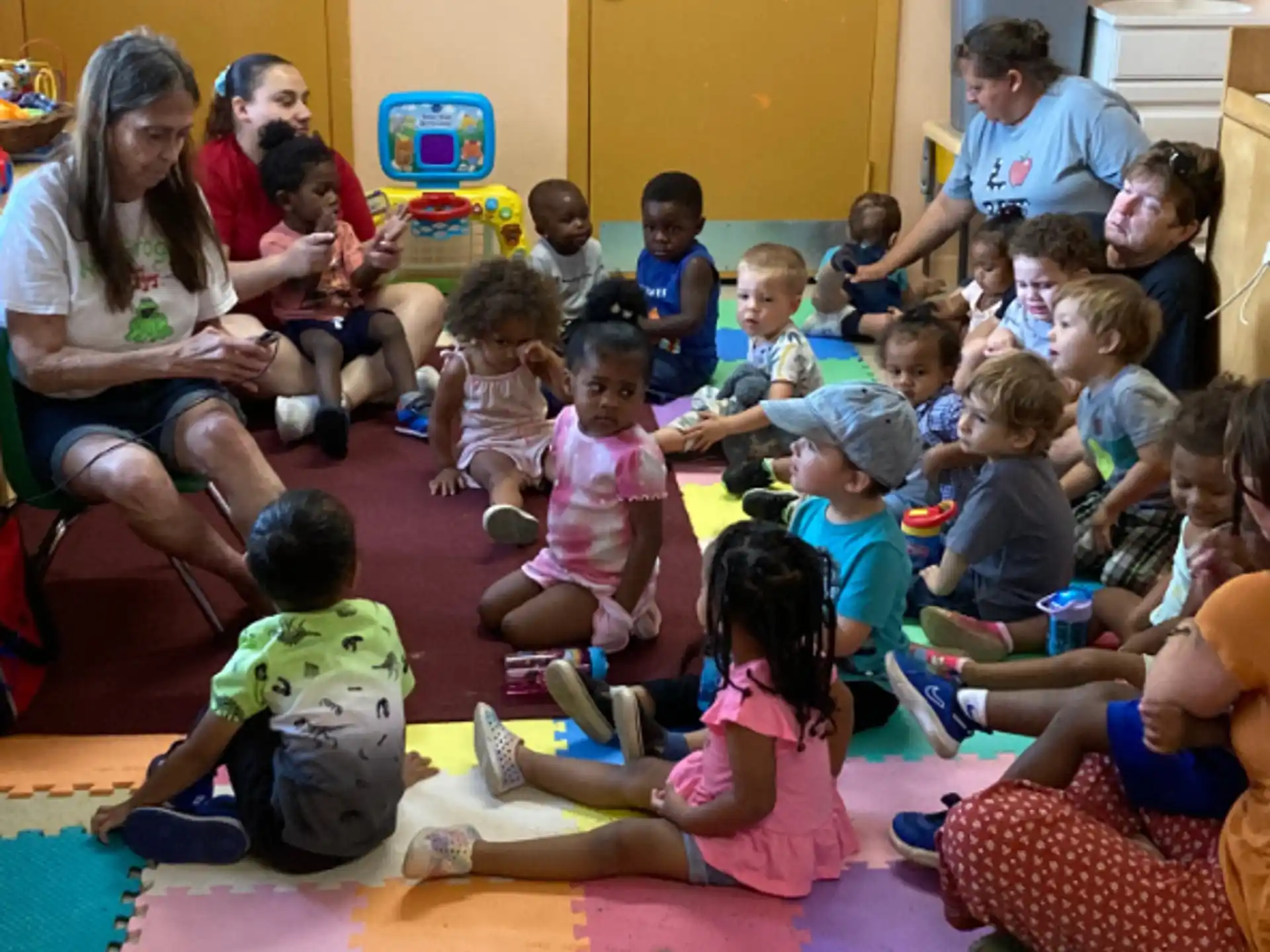 a group of children sitting on the floor