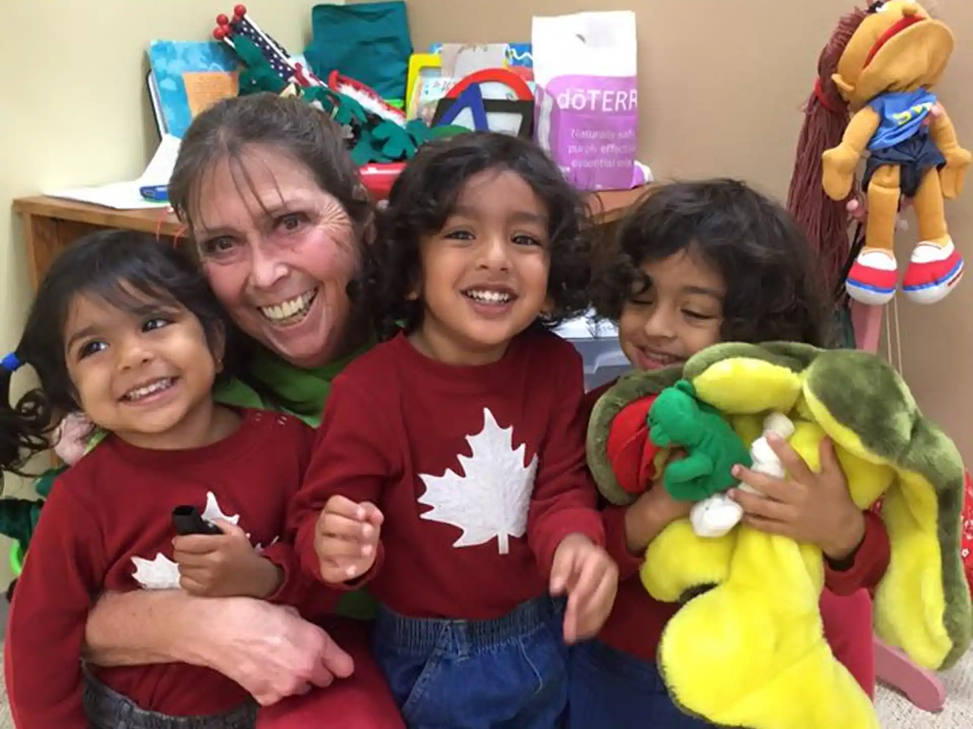 a person and two children holding toys