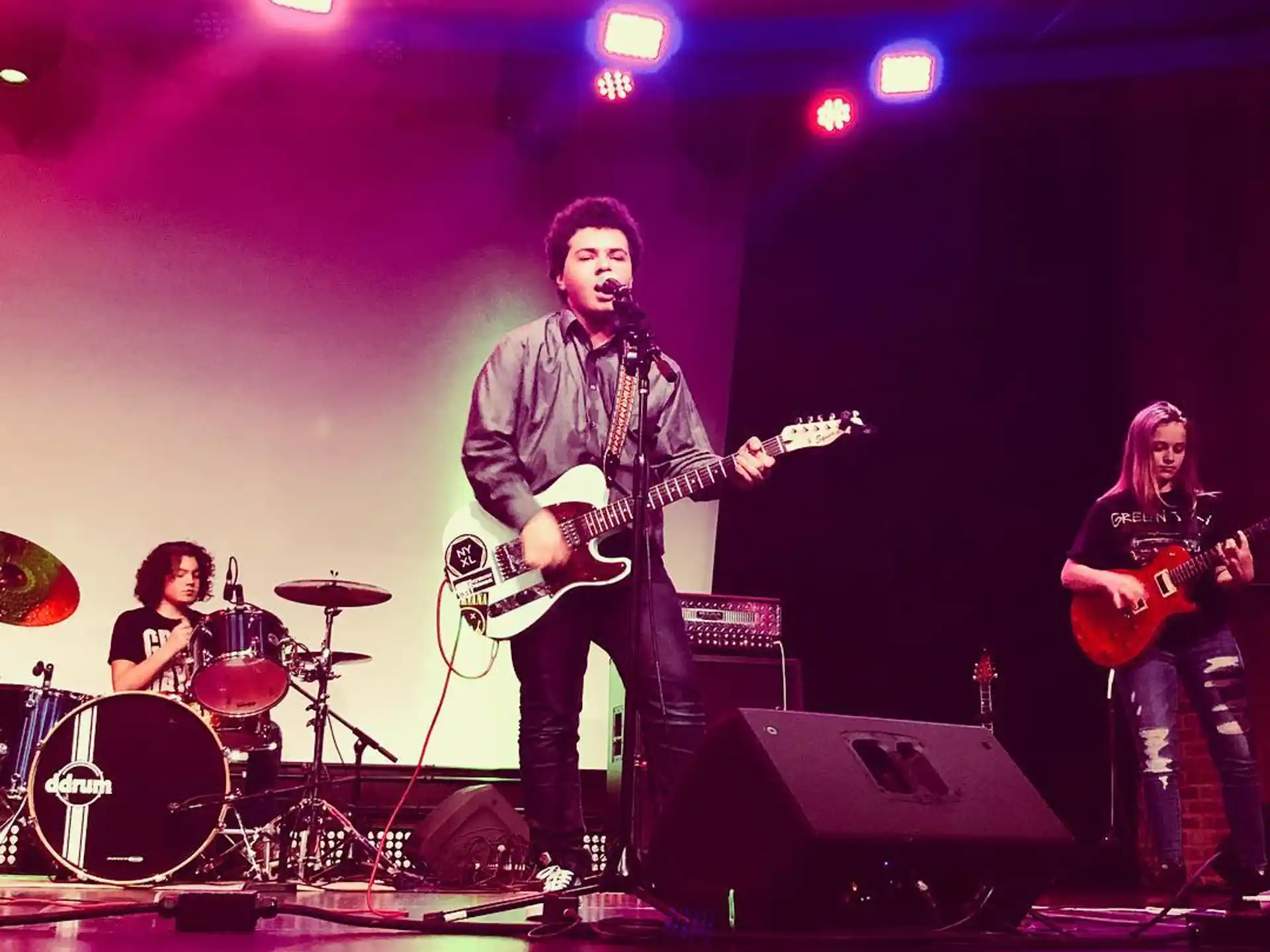 a group of people playing instruments on a stage