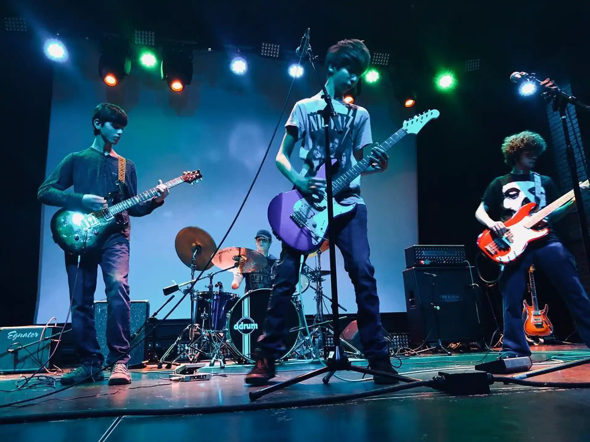 a group of people playing instruments on a stage