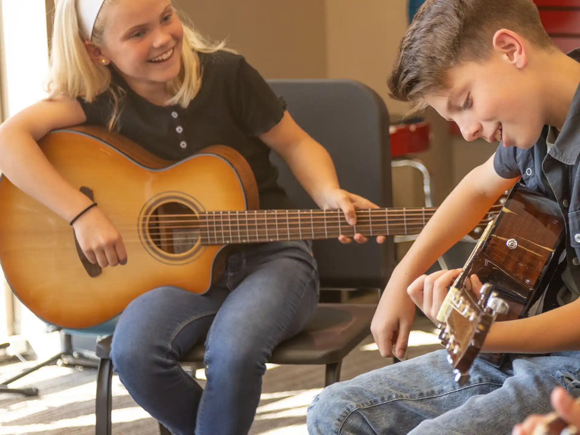 a man and a woman playing guitar