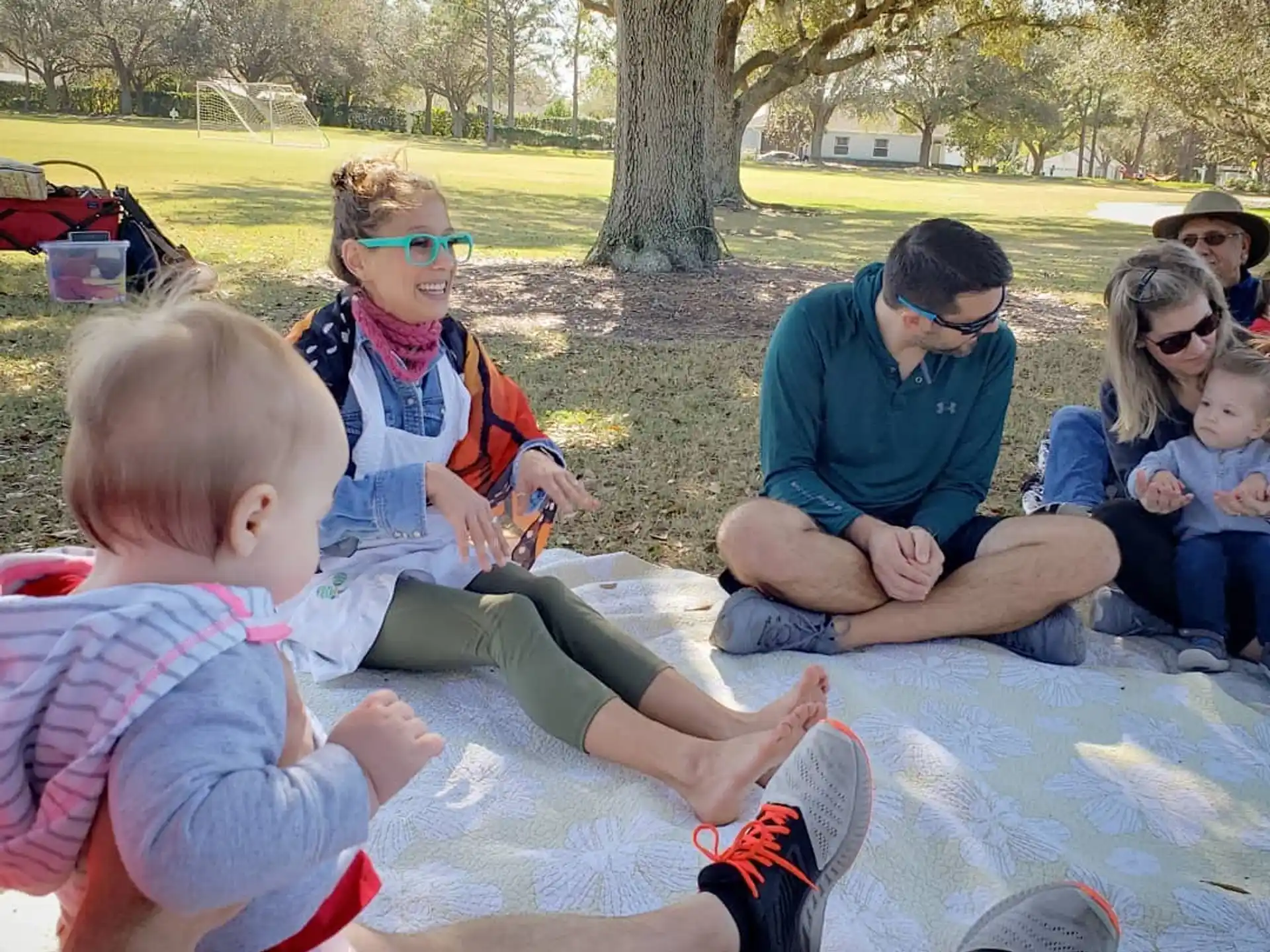 a group of people sitting on the grass