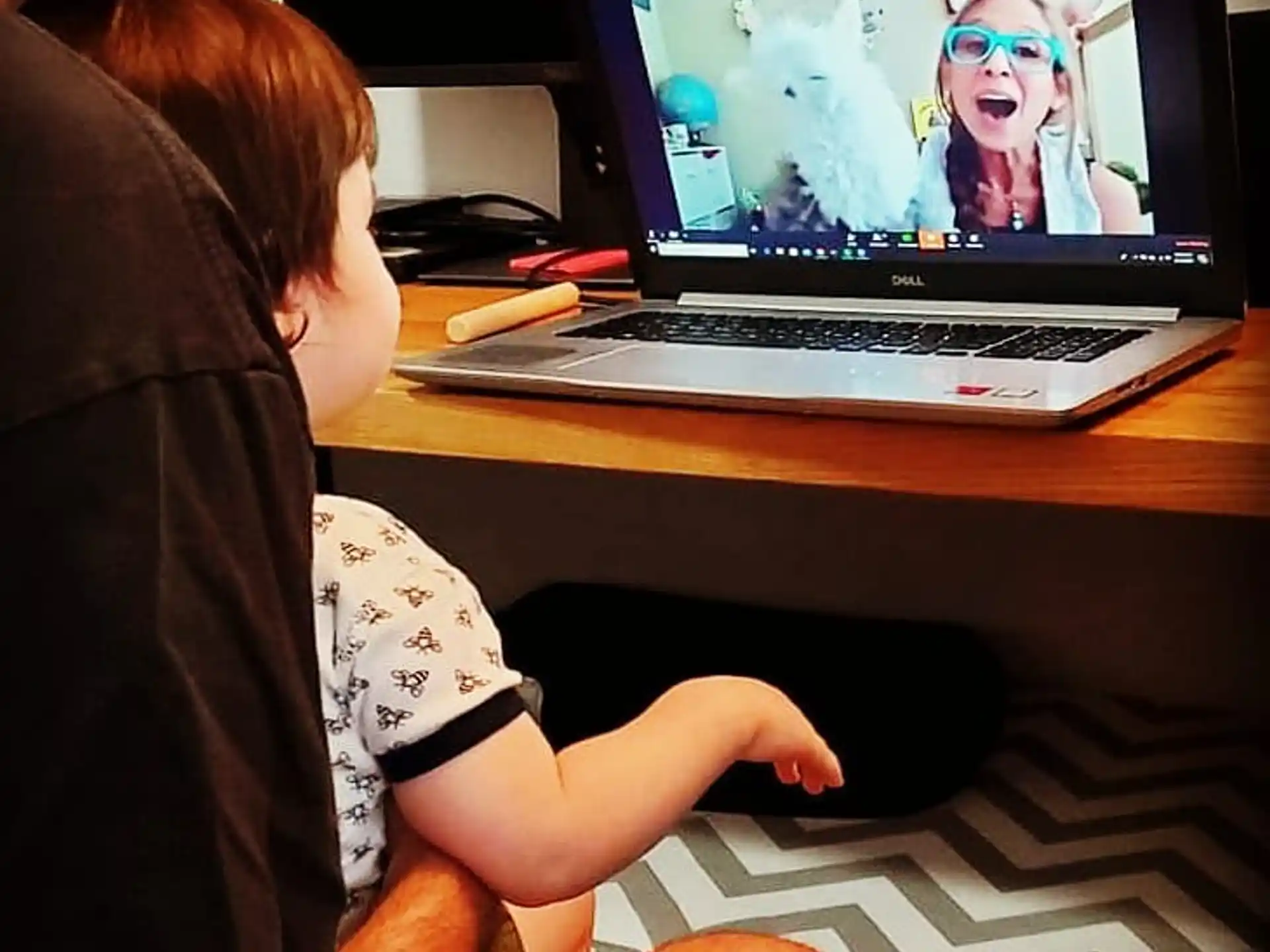 a person sitting in front of a laptop