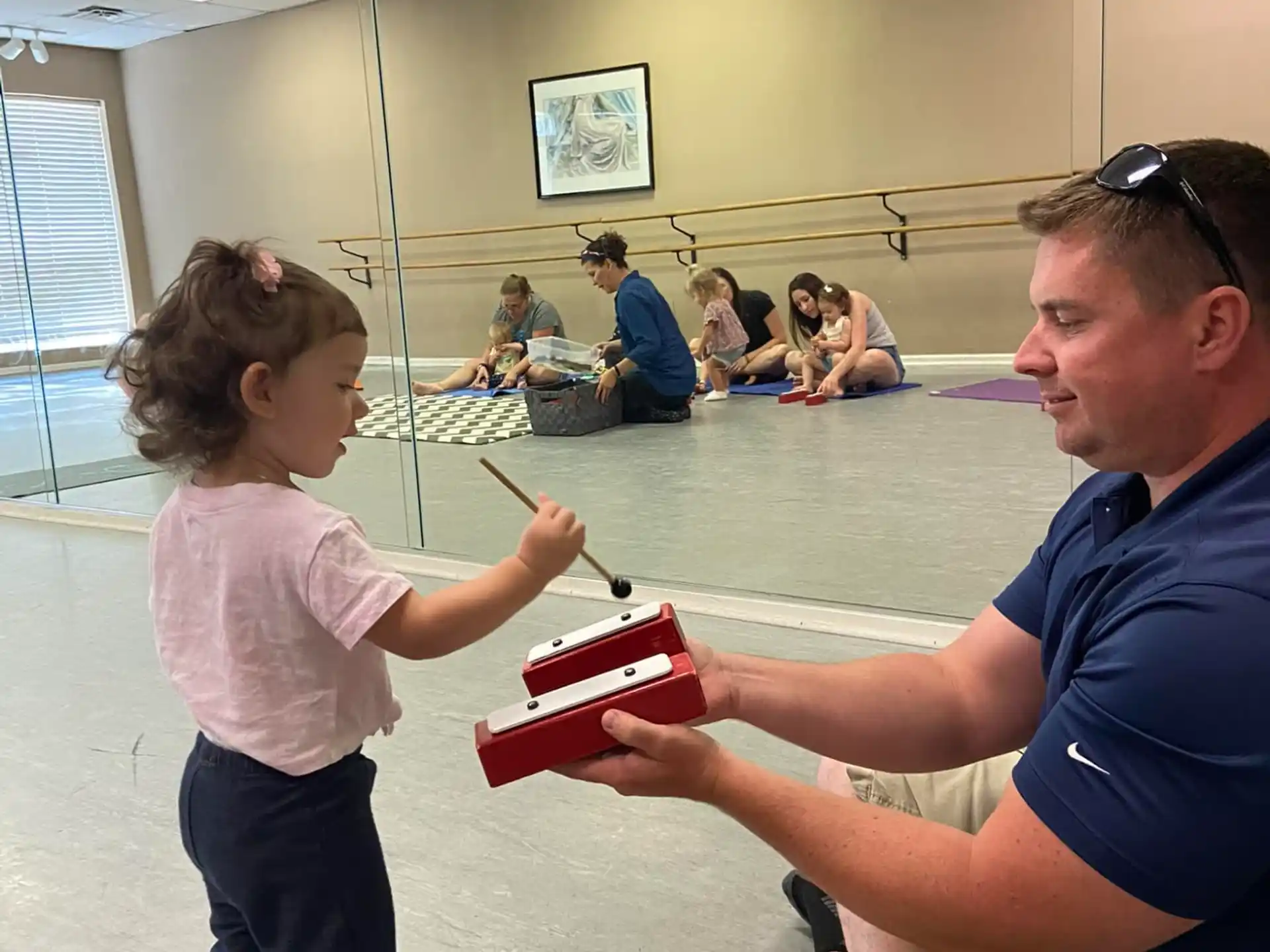 a person and a child playing with a toy