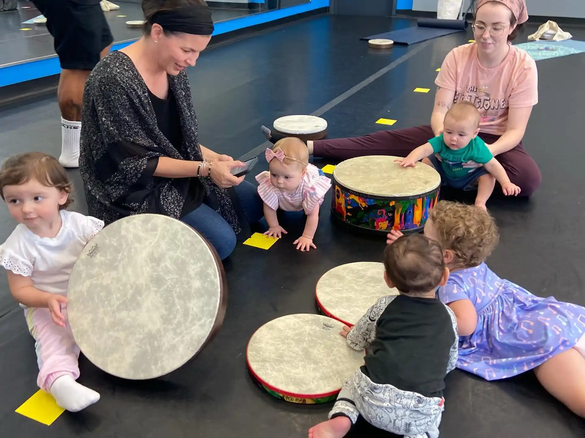 a person and several children playing with a person and a group of children