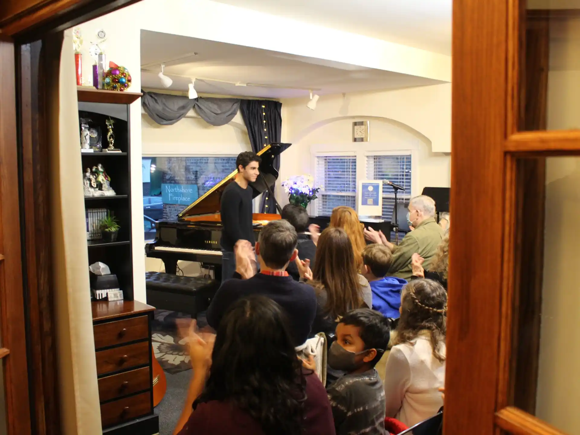 a person speaking to a group of people in a room