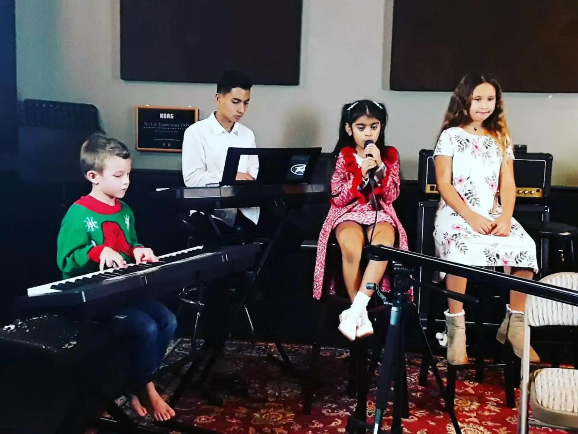 a group of people sitting at a piano