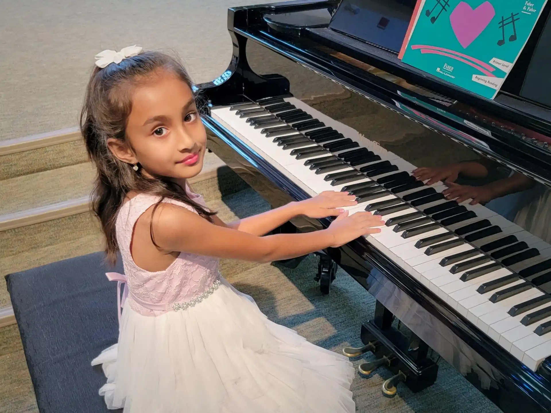 a girl playing a piano