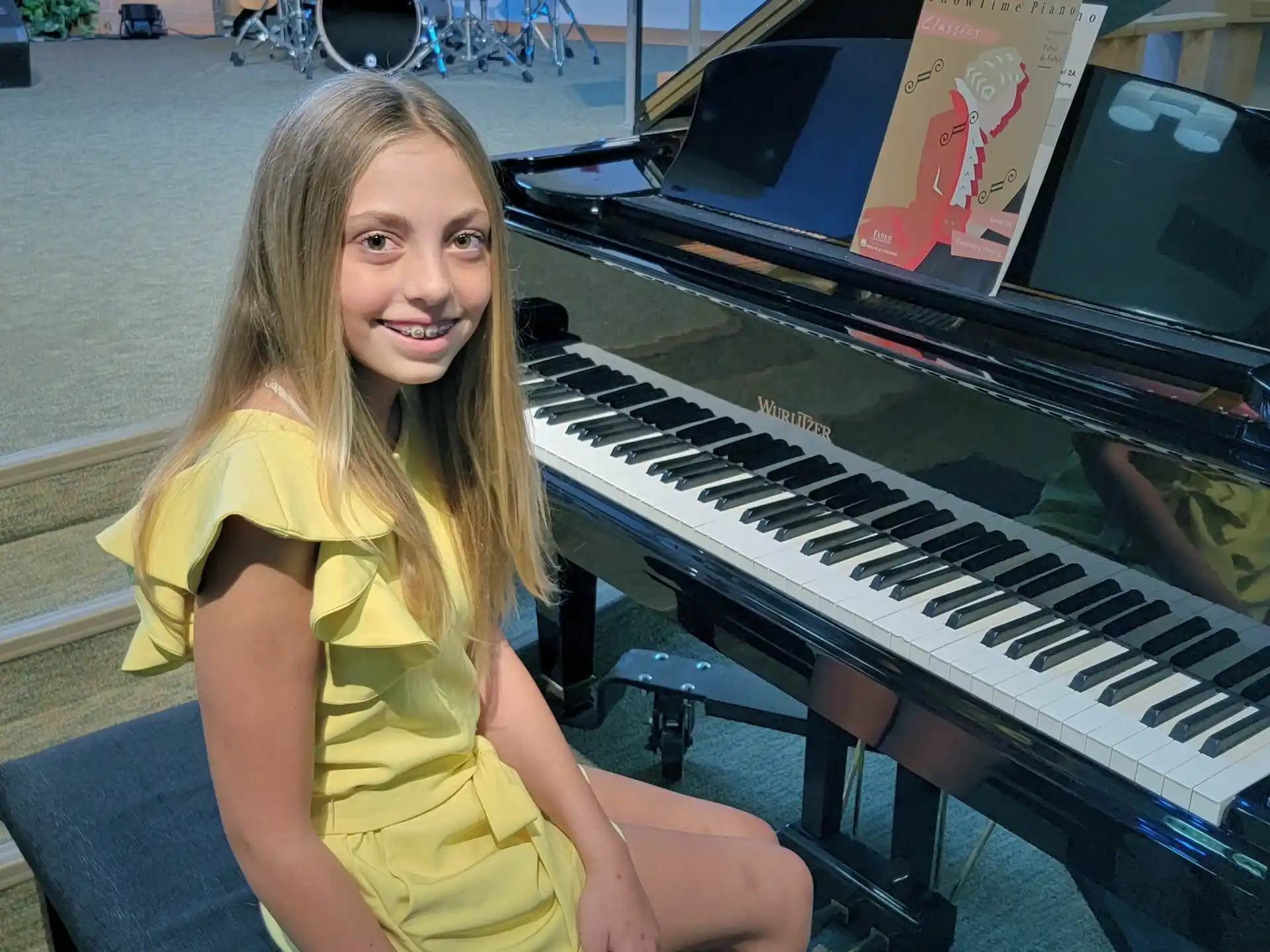 a person sitting next to a piano