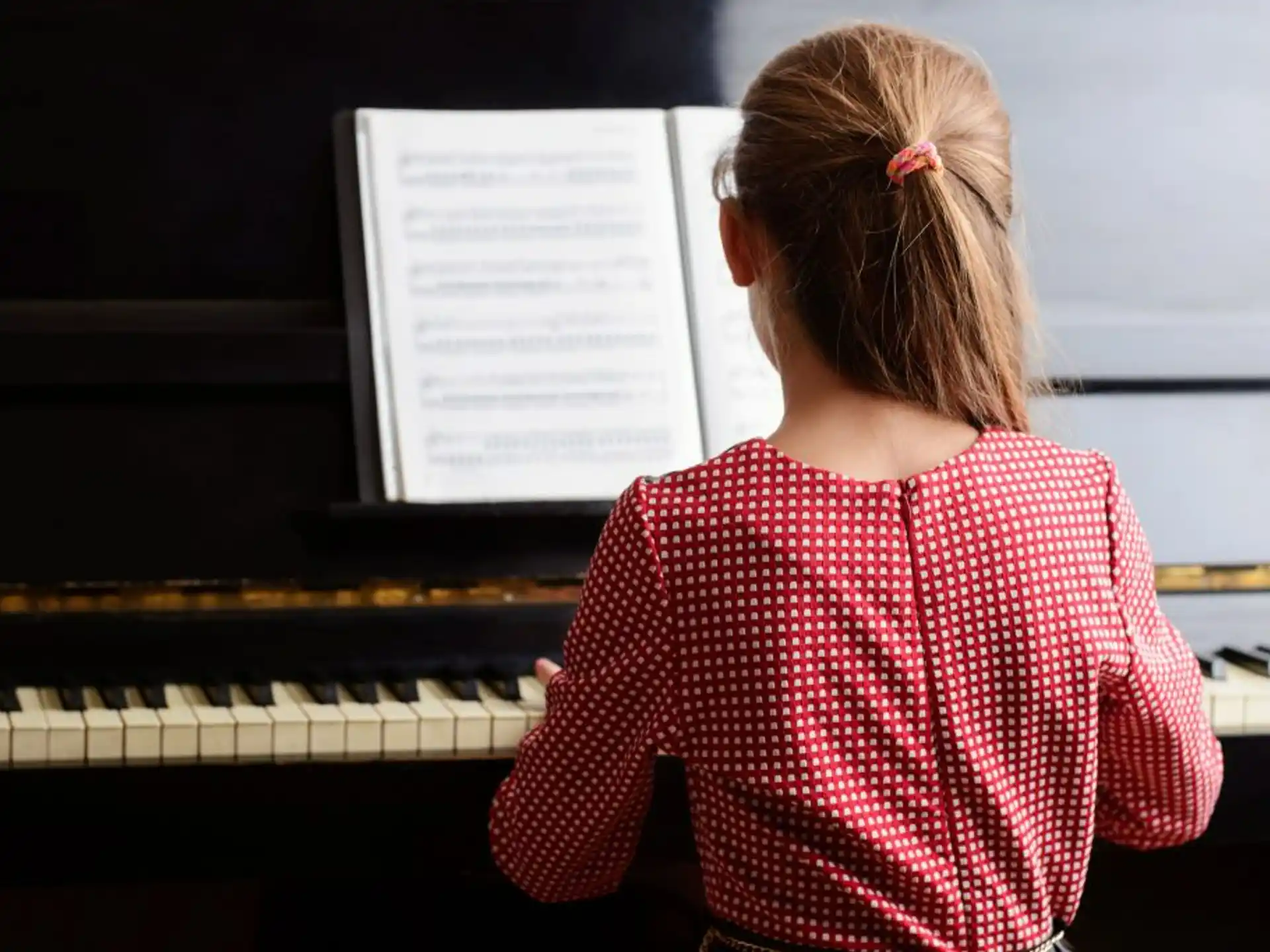 a girl playing a piano