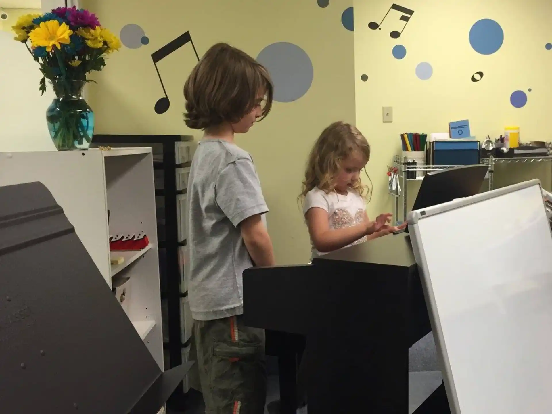 a couple of kids looking at a computer