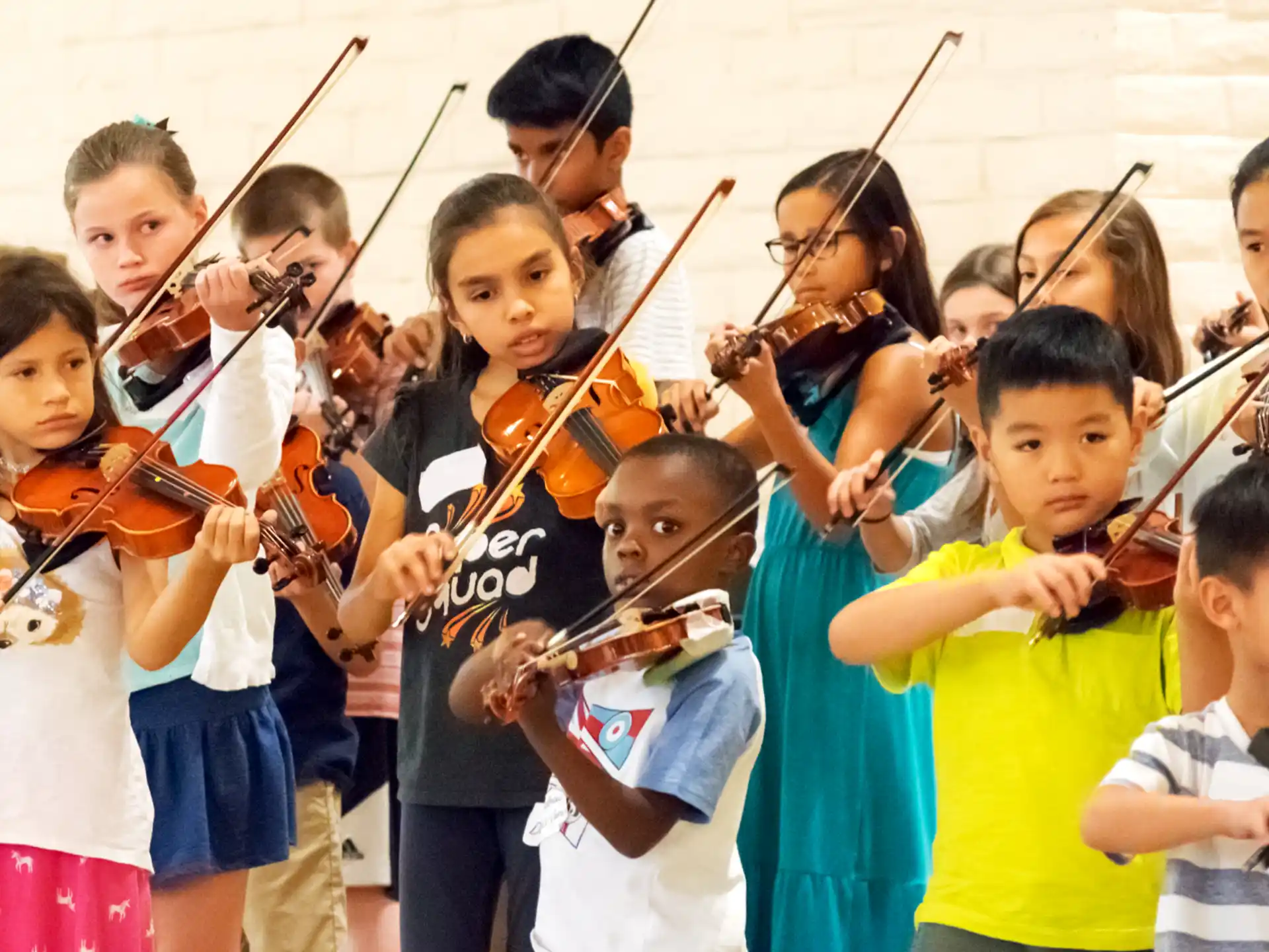 a group of children playing violin