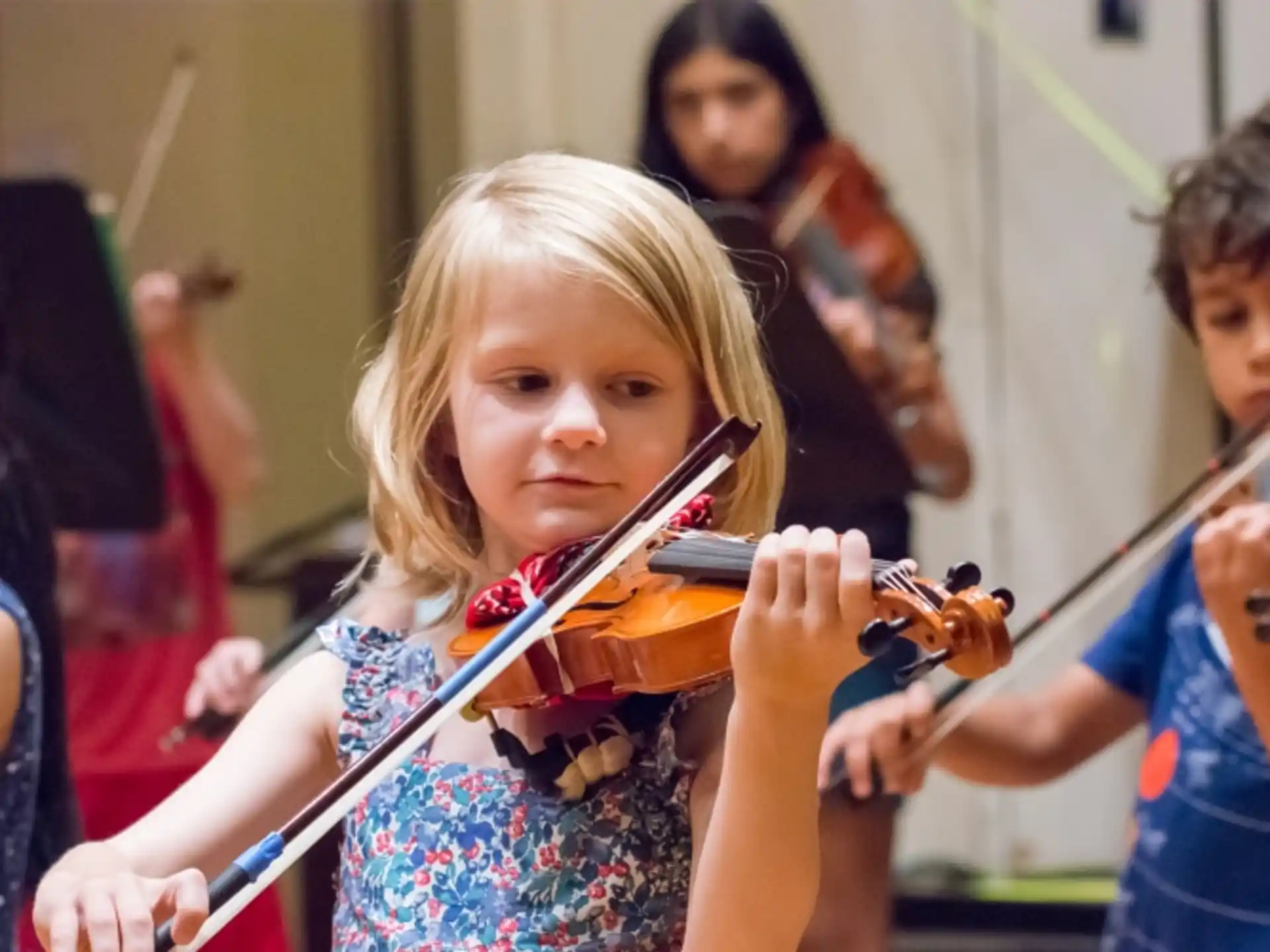 a young girl playing a violin