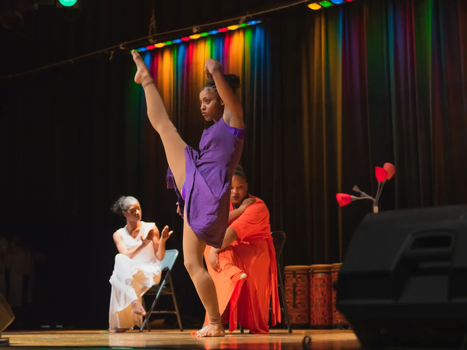 a person holding a child on a stage