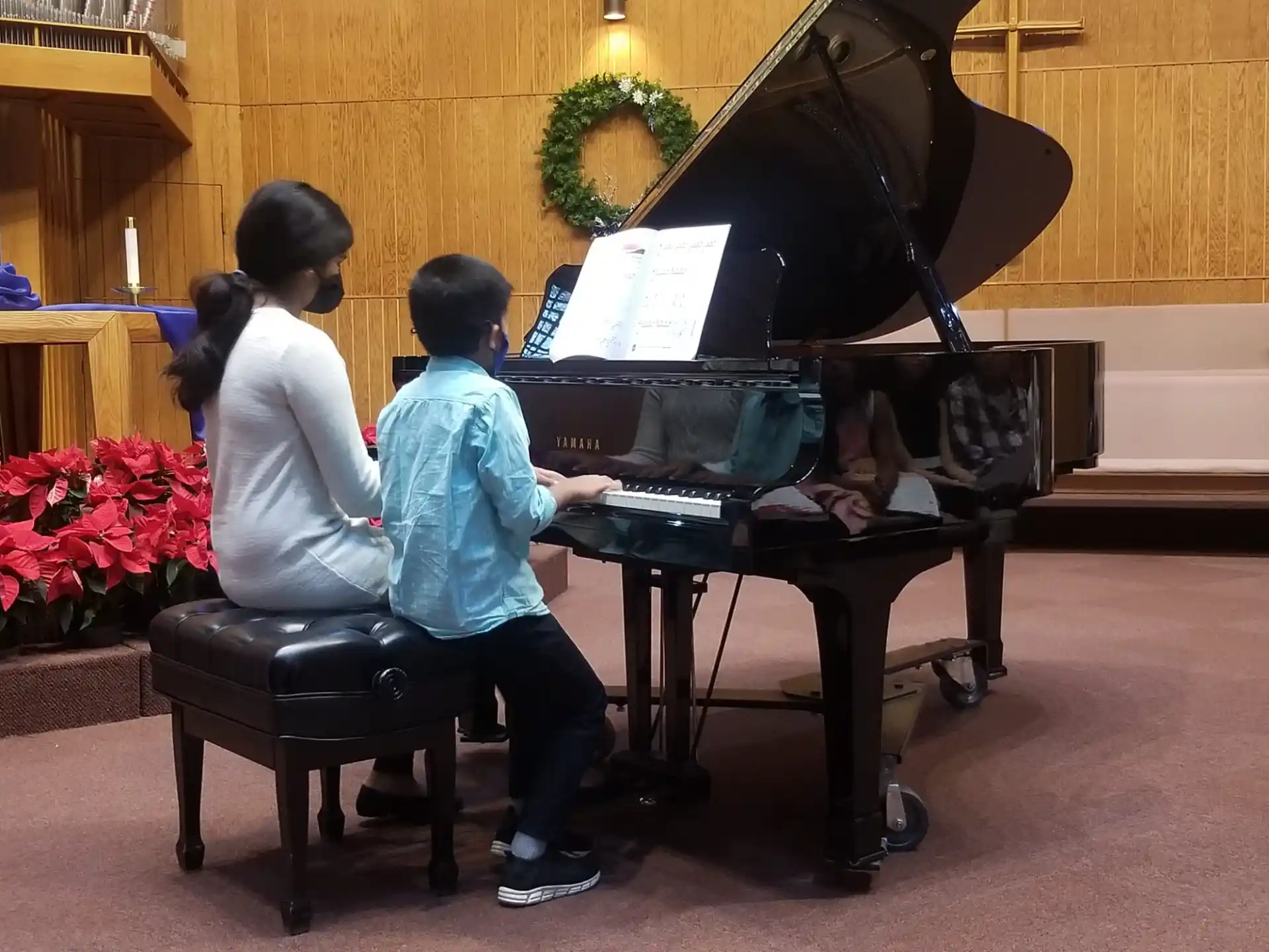 a group of people playing piano