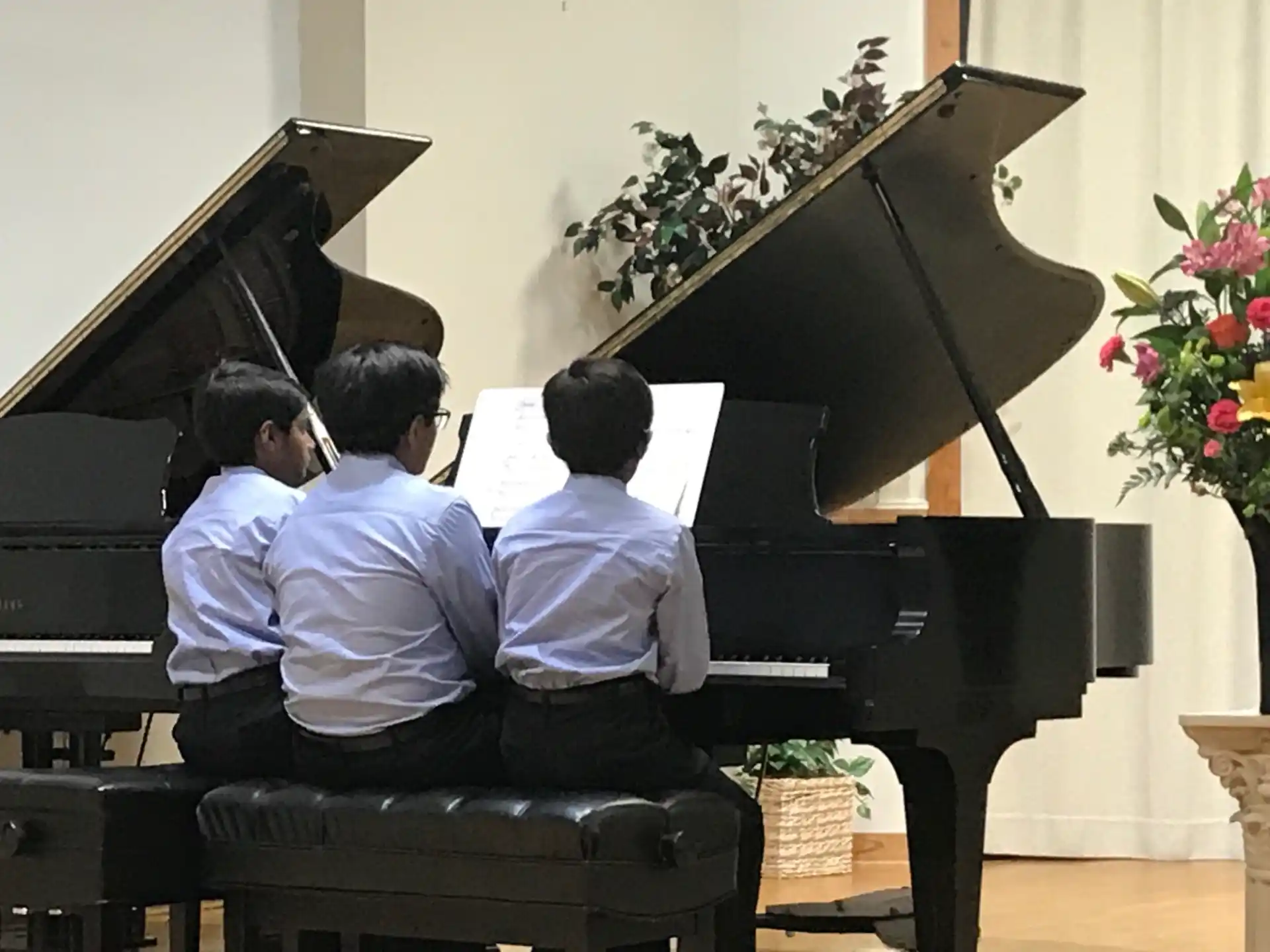 a group of people playing piano