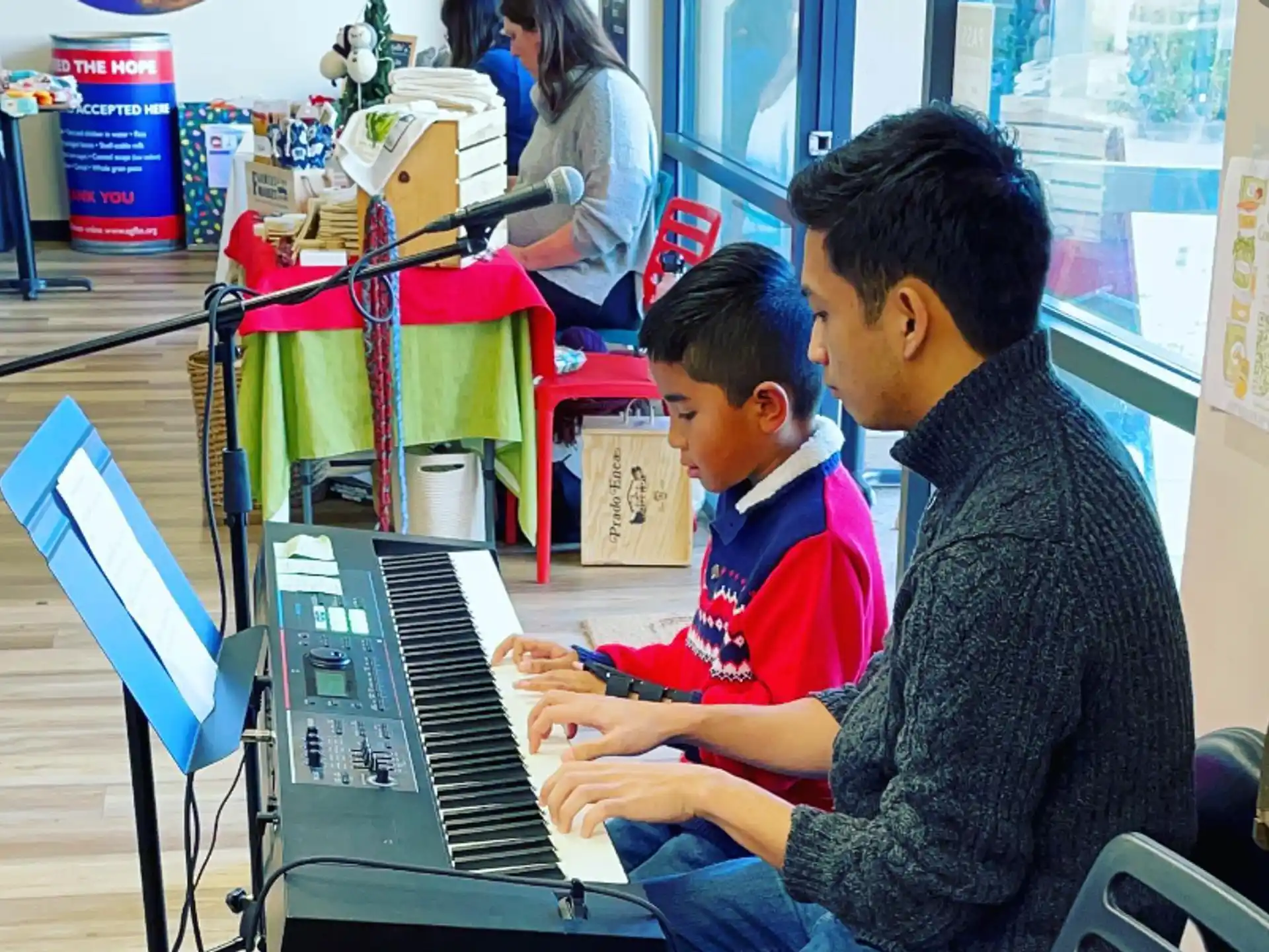 a couple of boys playing piano