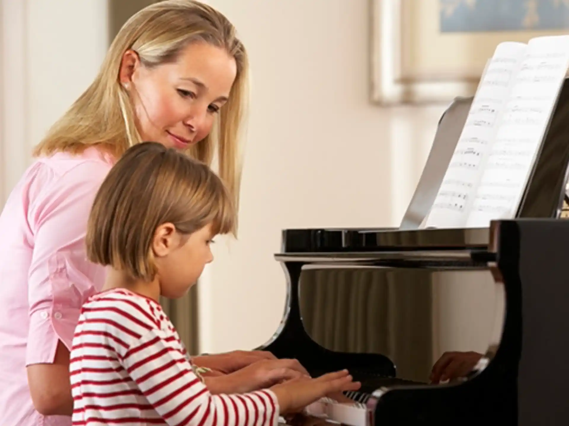 a woman and a child looking at a computer