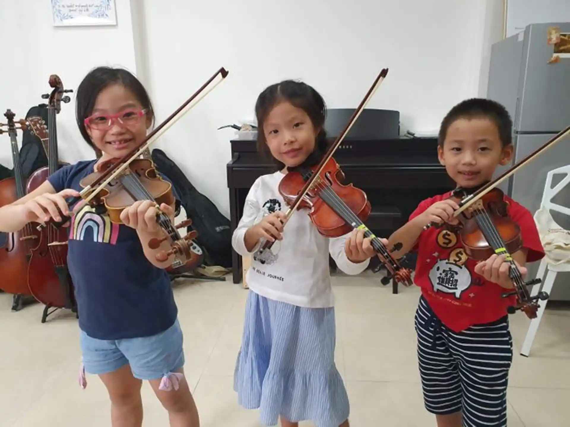 a group of kids holding violins