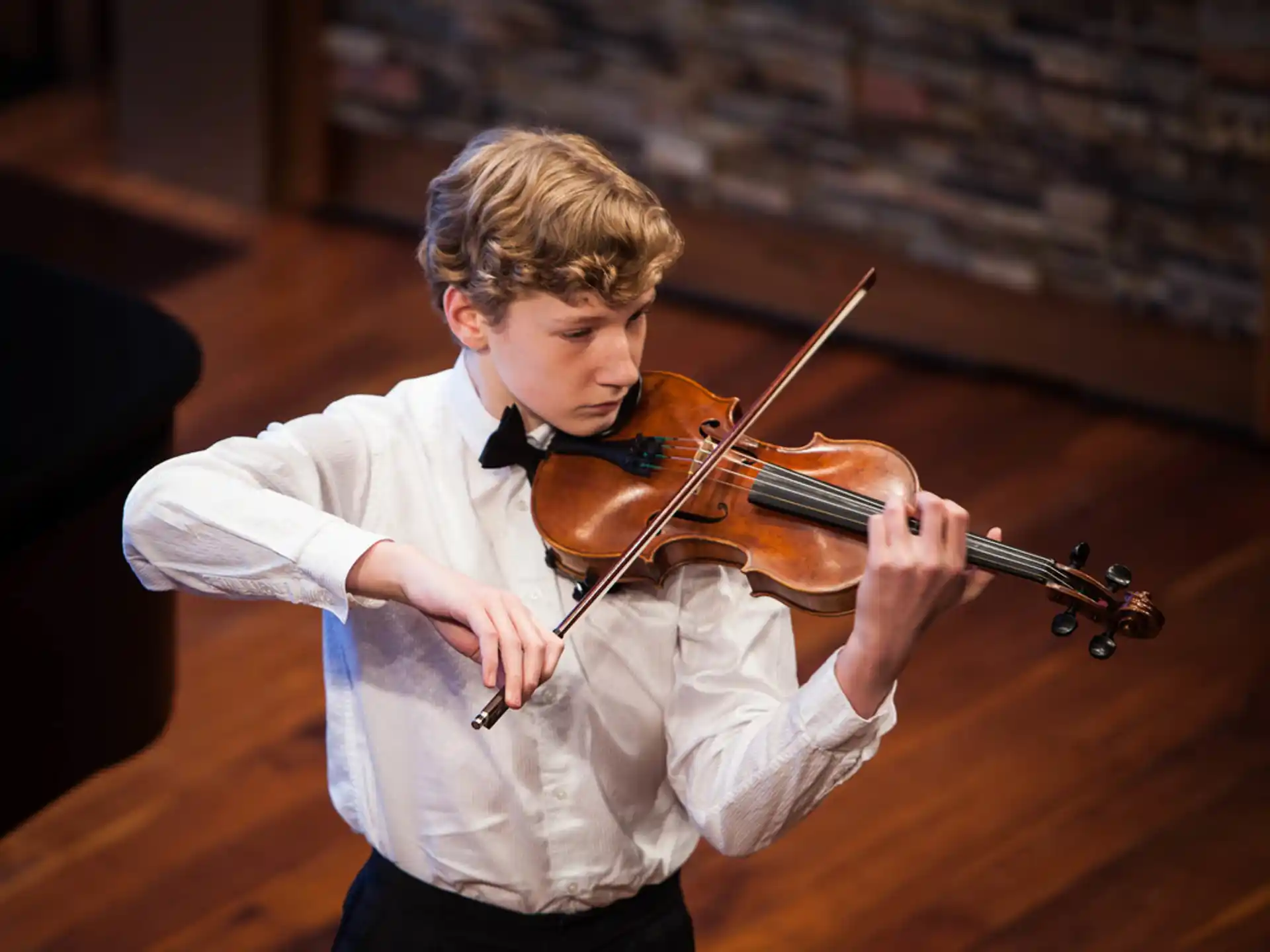 a boy playing a violin