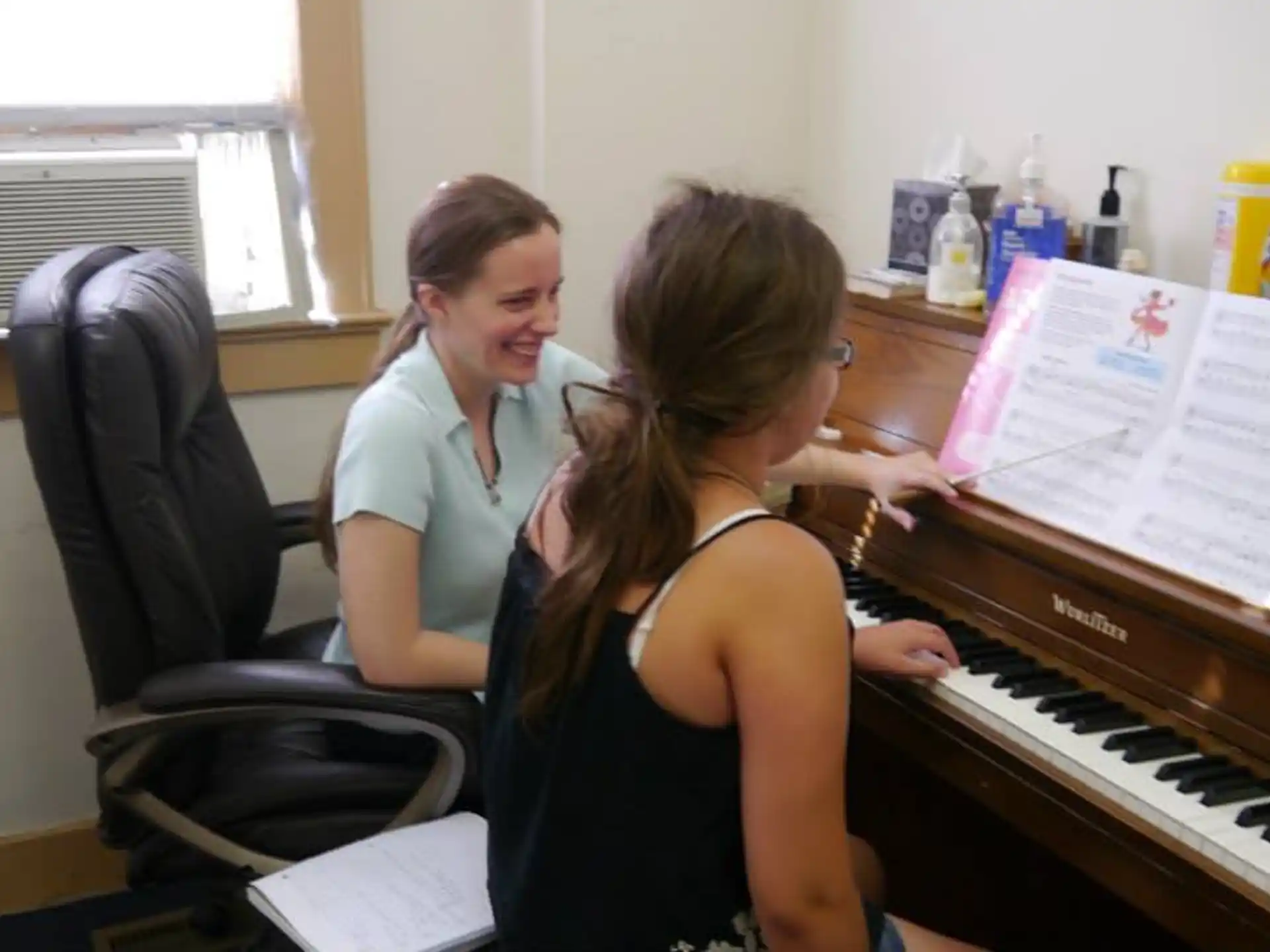 a woman playing a piano