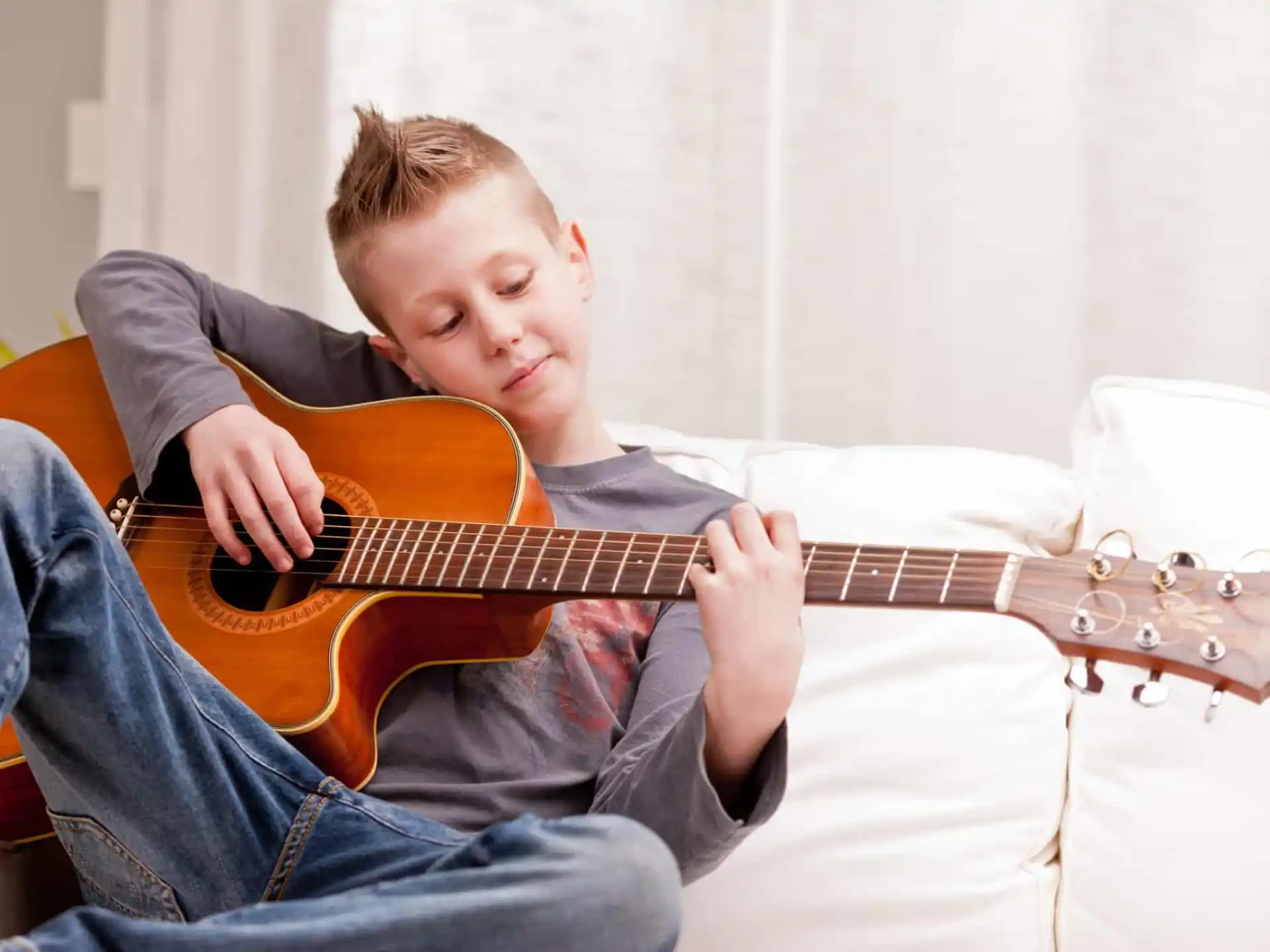 a boy playing a guitar