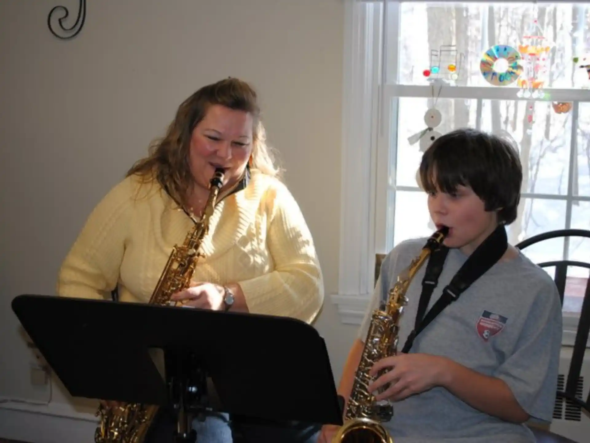 a woman and a boy playing instruments