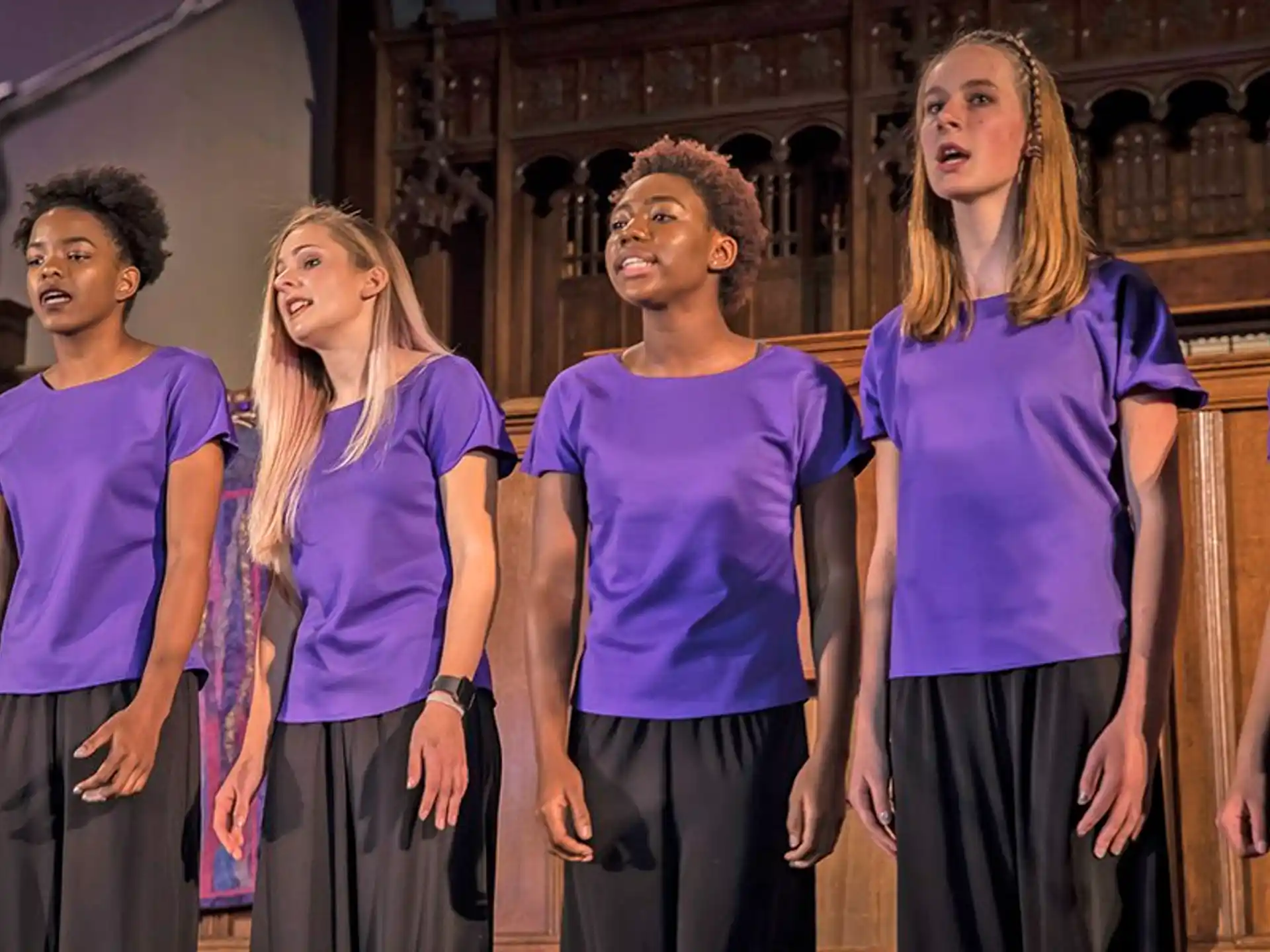 a group of people in purple shirts