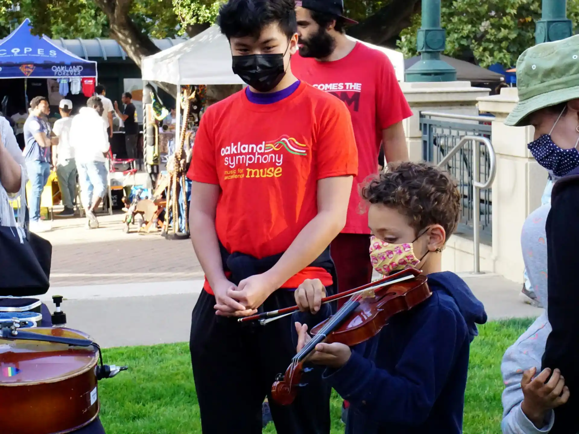 a person and a boy playing drums