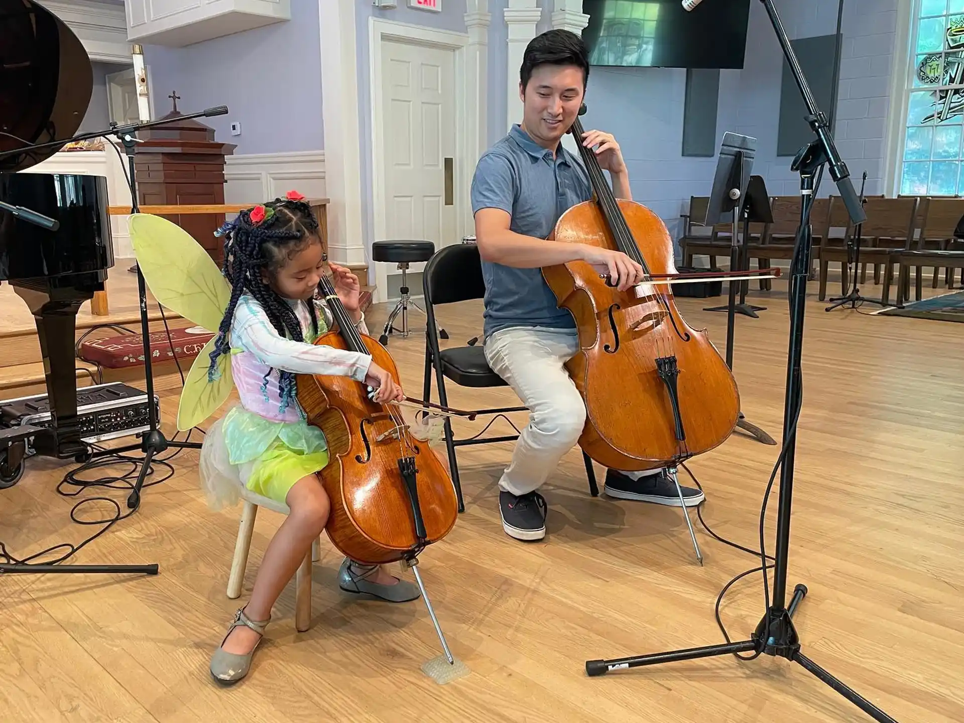 a person and a girl playing the violin