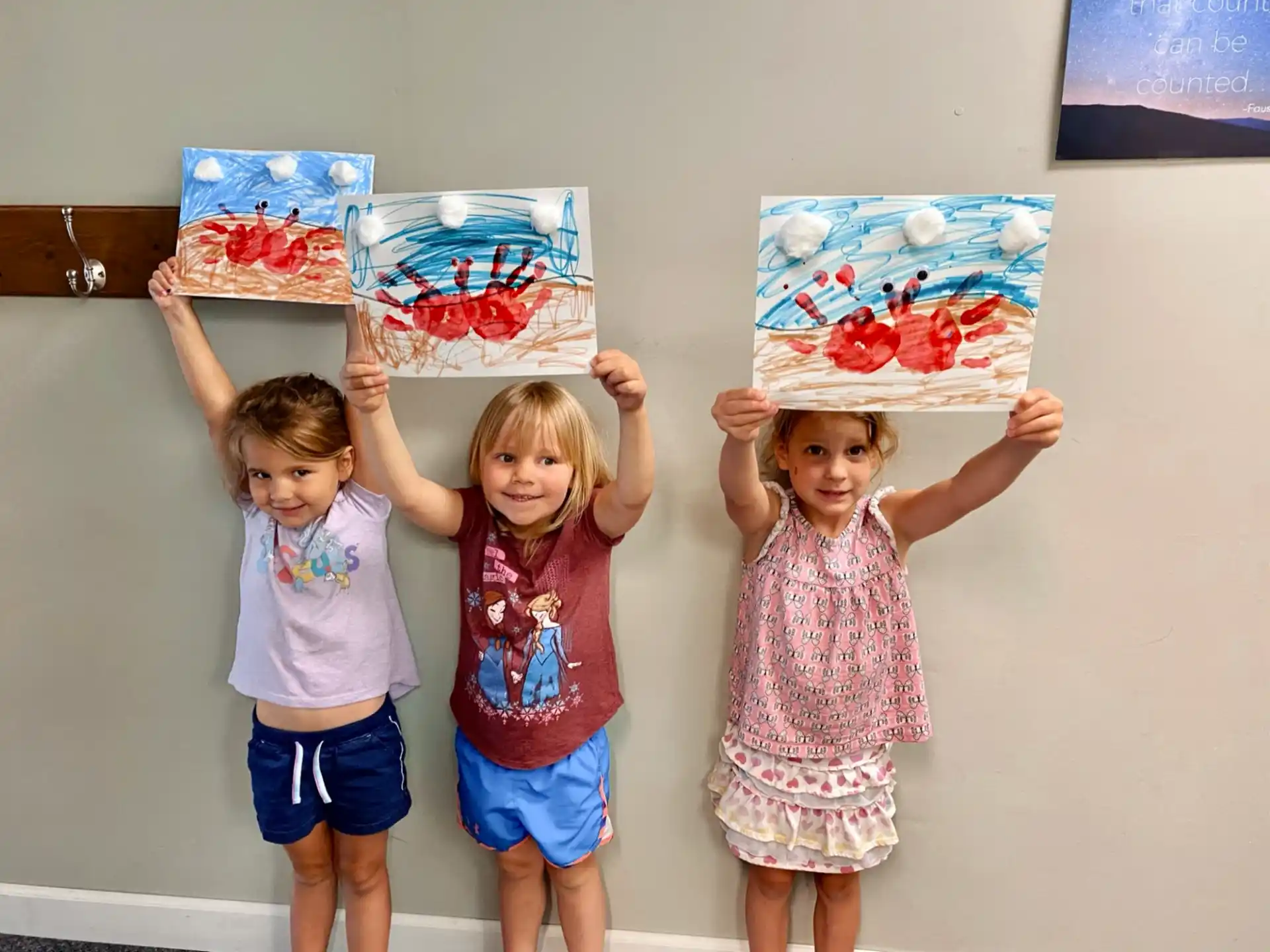 a group of children holding up a cake