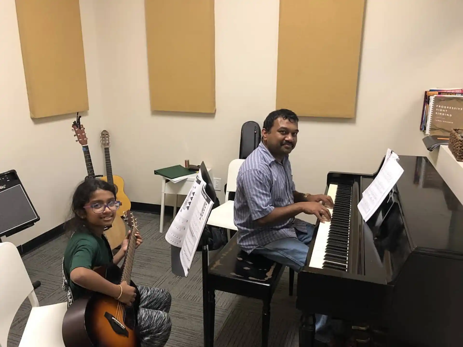 a man and a woman playing the piano