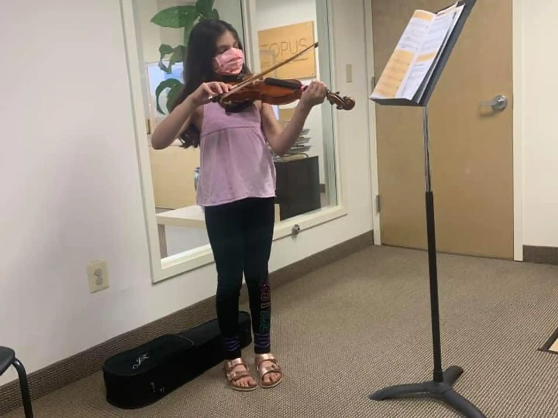 a woman playing a violin