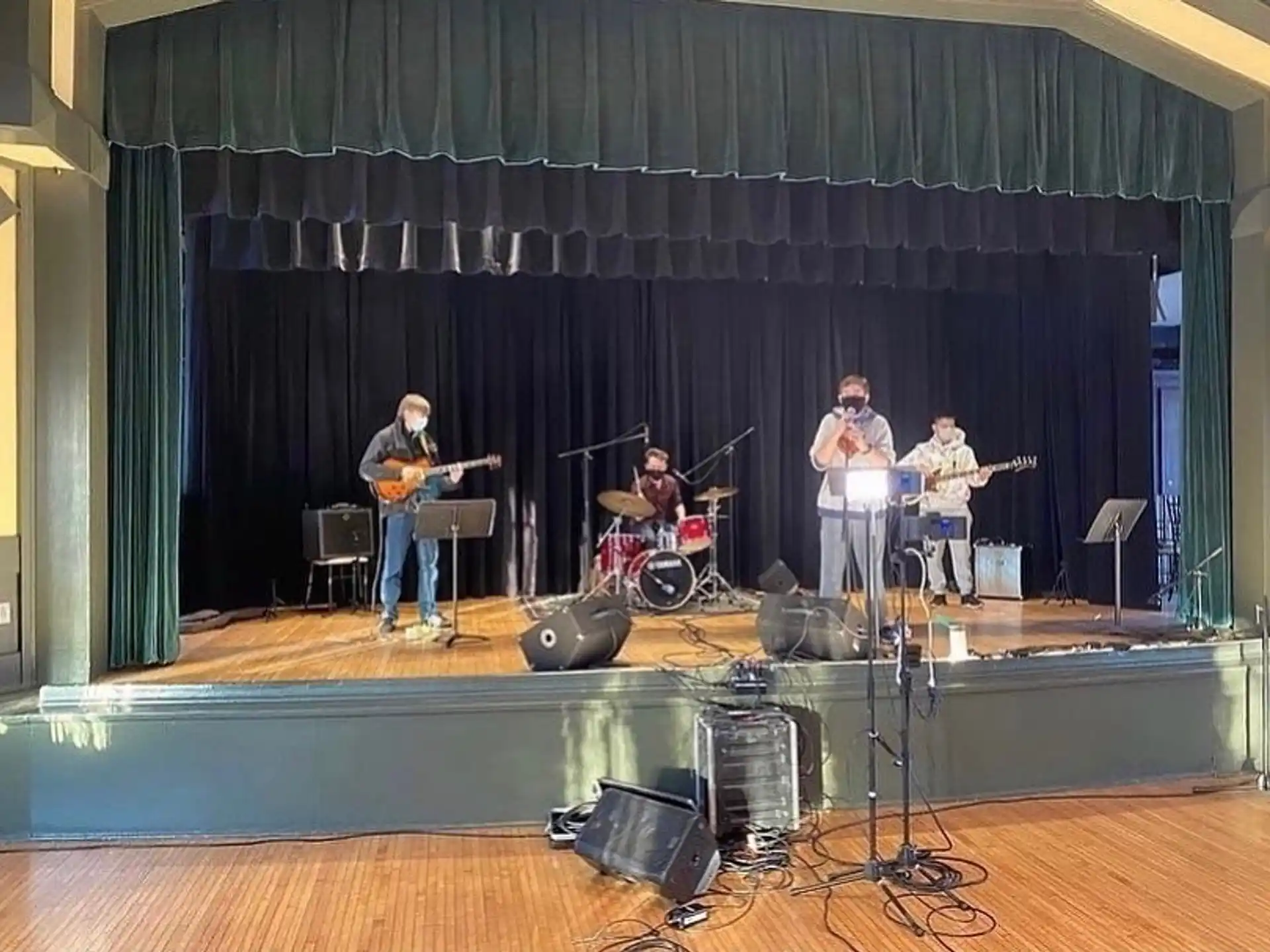 a group of people playing instruments on a stage